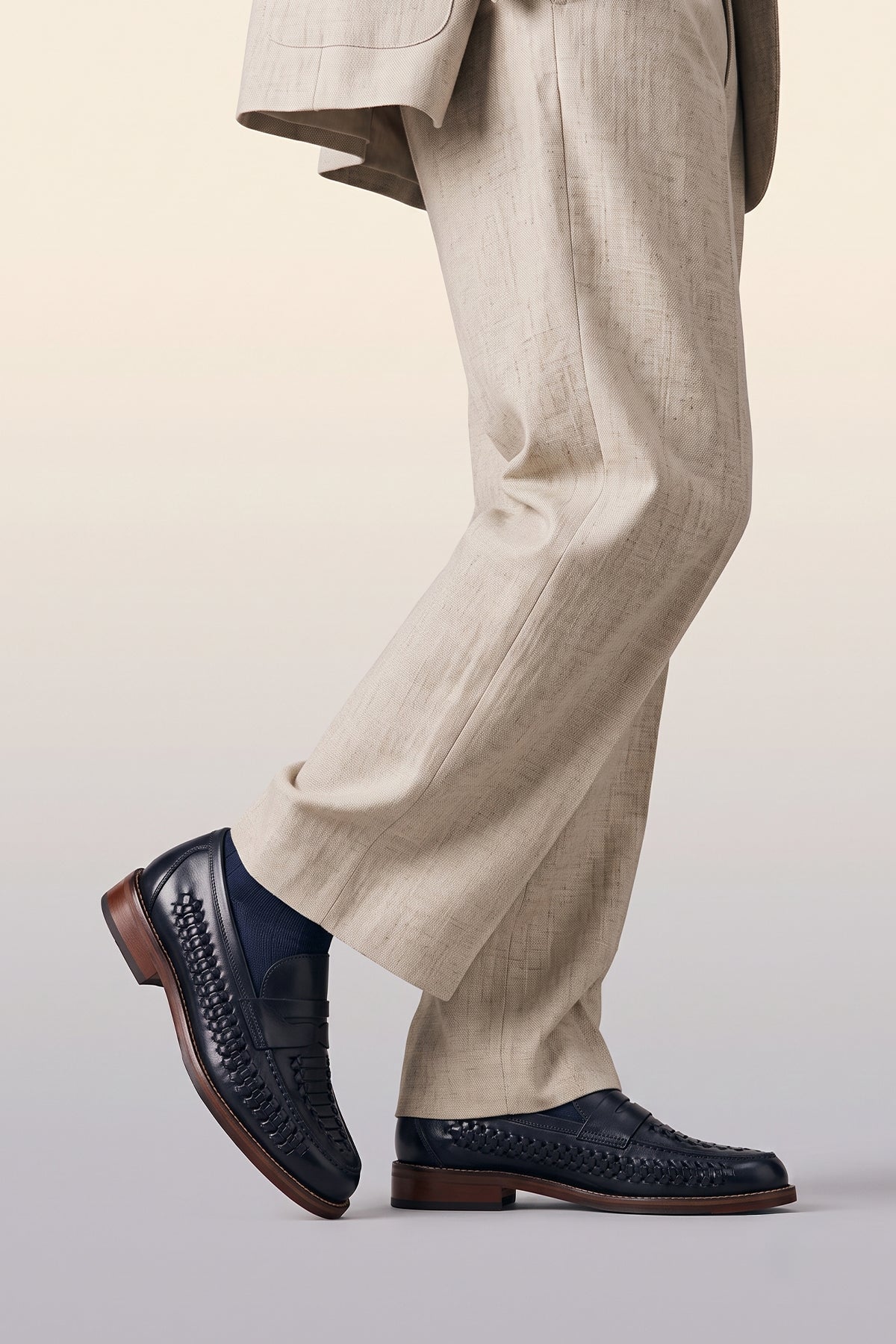 Model wearing Finley navy woven leather loafers for men, featuring premium craftsmanship, intricate weave detail, and a refined, durable finish