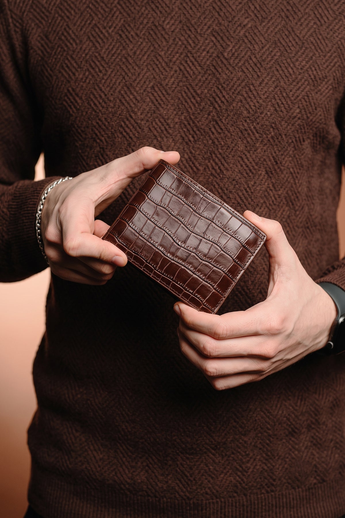 Man holding Marylebone navy saffiano leather bi-fold wallet for men by Oswin Hyde – slim luxury wallet with multiple card slots and durable textured leather finish.