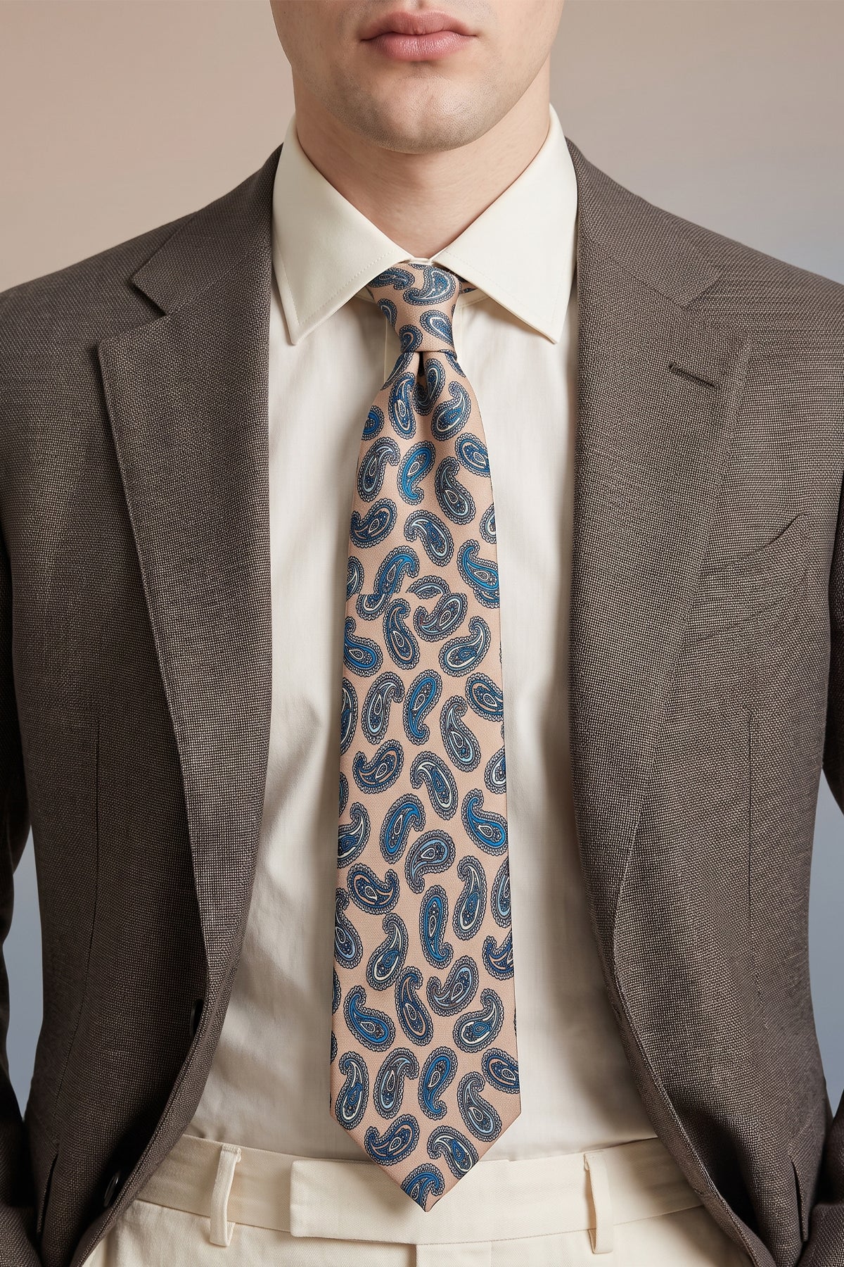 Man wearing Paisley Champagne tie with sophisticated design, perfect for weddings, office wear, and casual events.