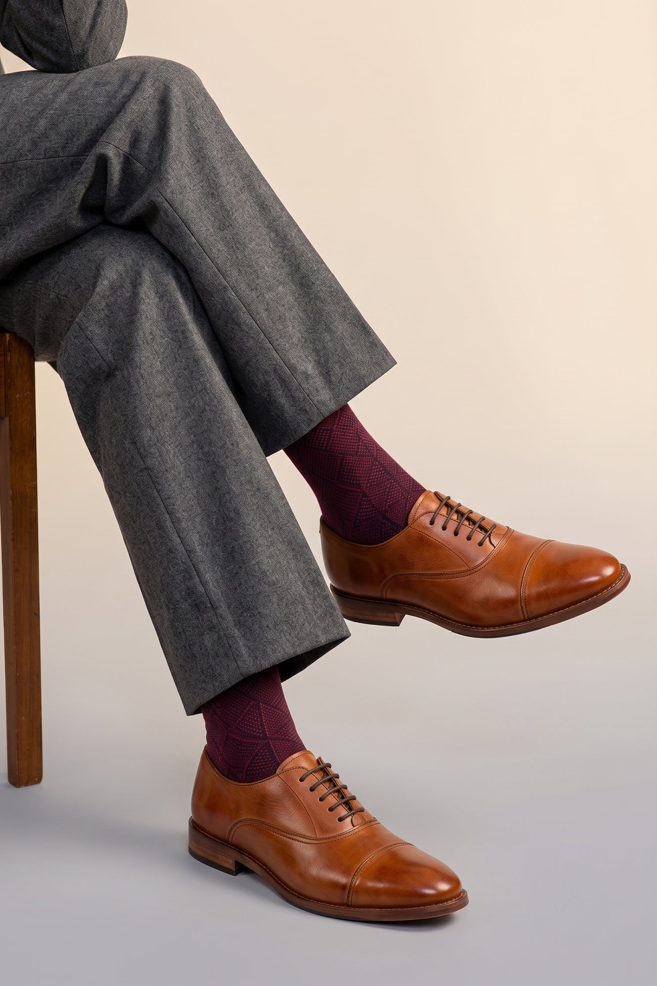 Model wearing Wilson tan leather Oxford shoes for men with five-eyelet toecap design, showcasing timeless elegance and polished craftsmanship