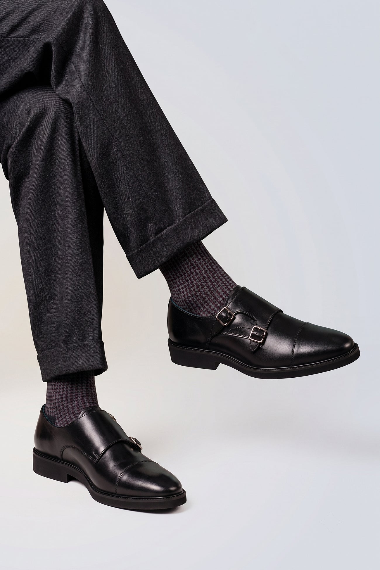 Model wearing Garson Black double monk strap leather shoes for men by Oswin Hyde – elegant formal shoes with polished finish and cushioned leather insole