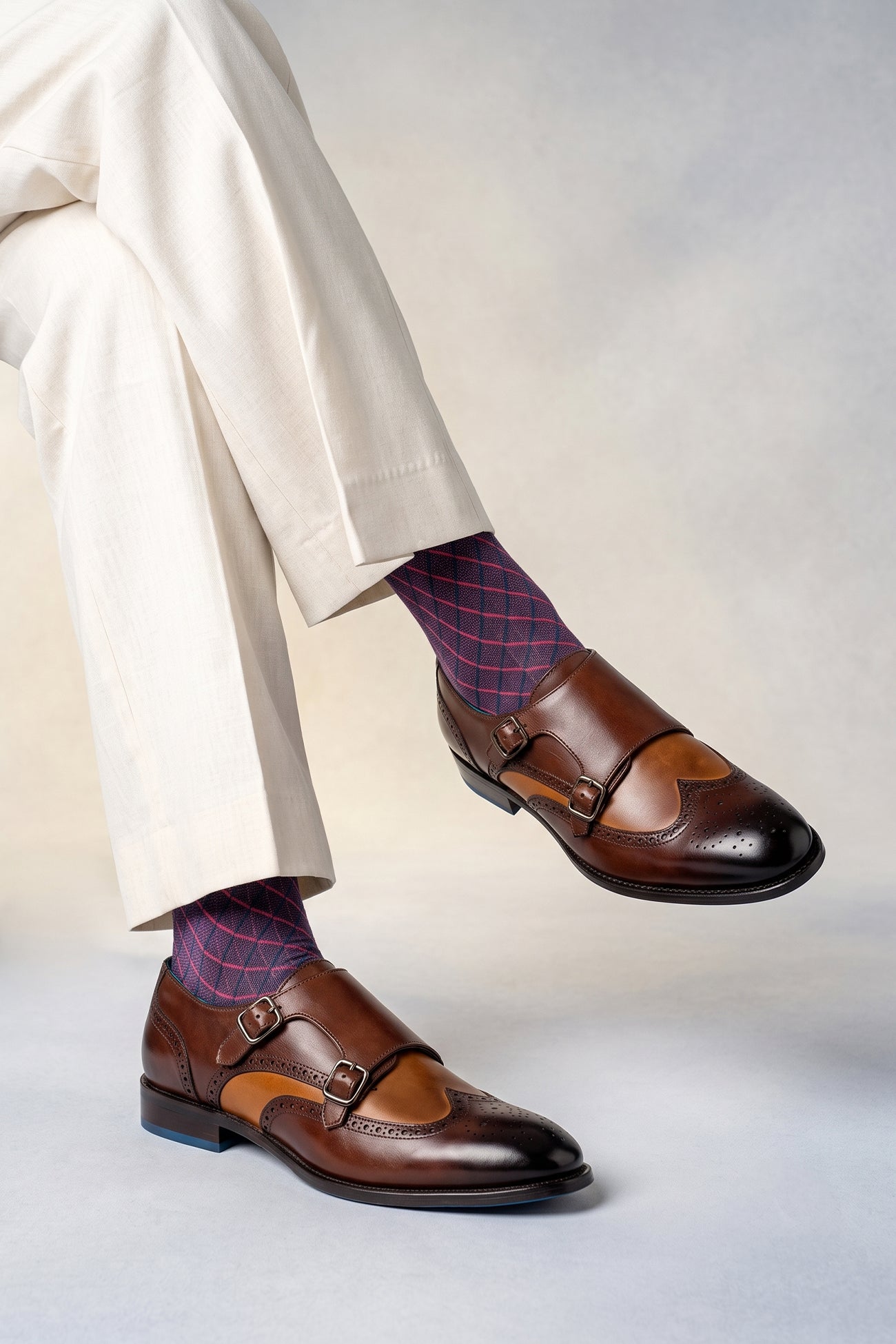 Man wearing Warren brown monk strap wing cap brogue men’s leather shoes featuring premium leather and detailed wingtip perforations.