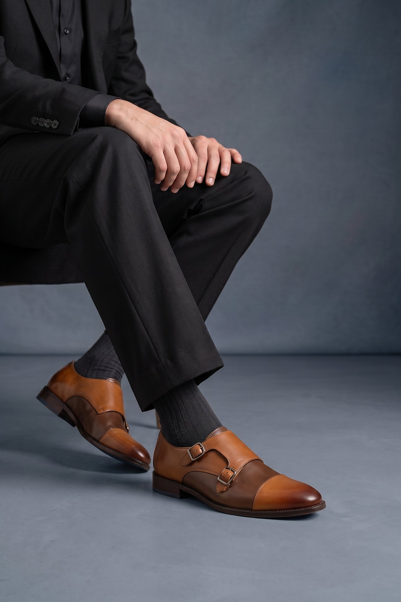 Model wearing Oscar tan brown monk strap leather shoes for men with tweed accents, crafted for formal and smart-casual occasions.