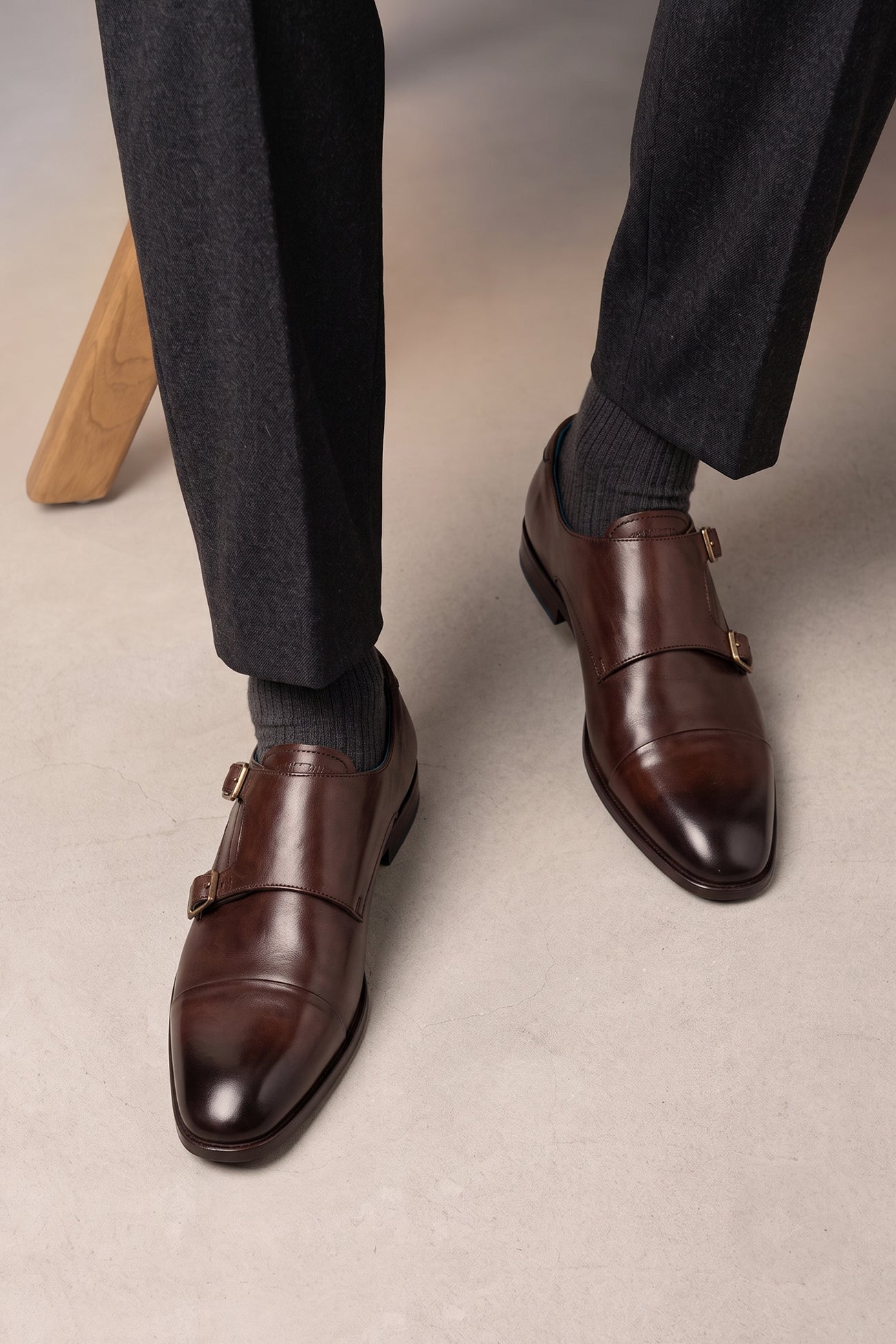 Model wearing Hadley brown monk strap leather men’s shoes with single buckle design, crafted in high-quality leather and finished with a sleek leather sole.