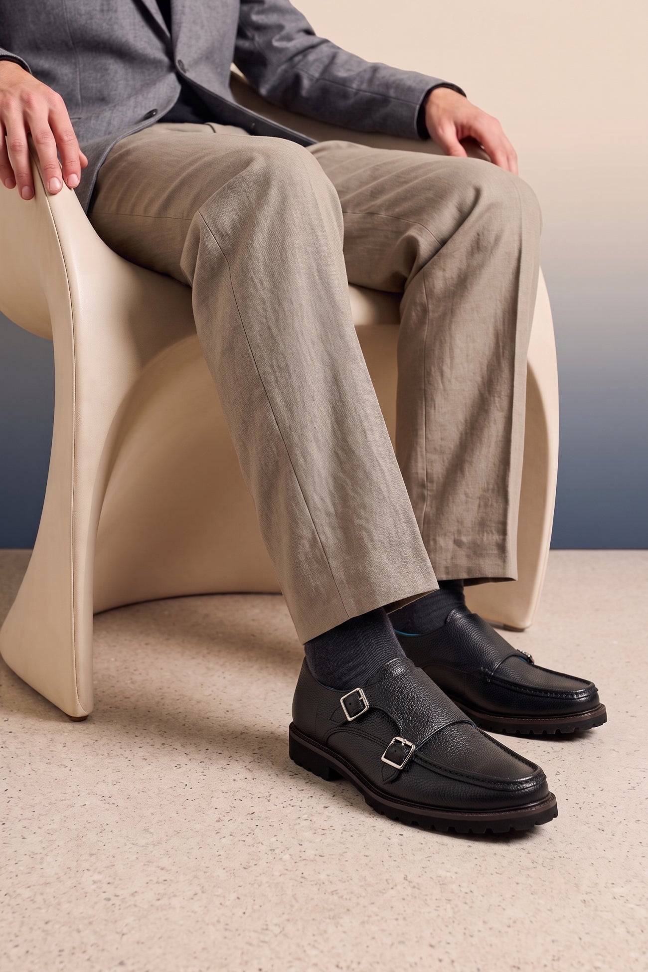 Model wearing Men’s black monk strap shoes with lightweight cushioned sole and sleek leather upper.