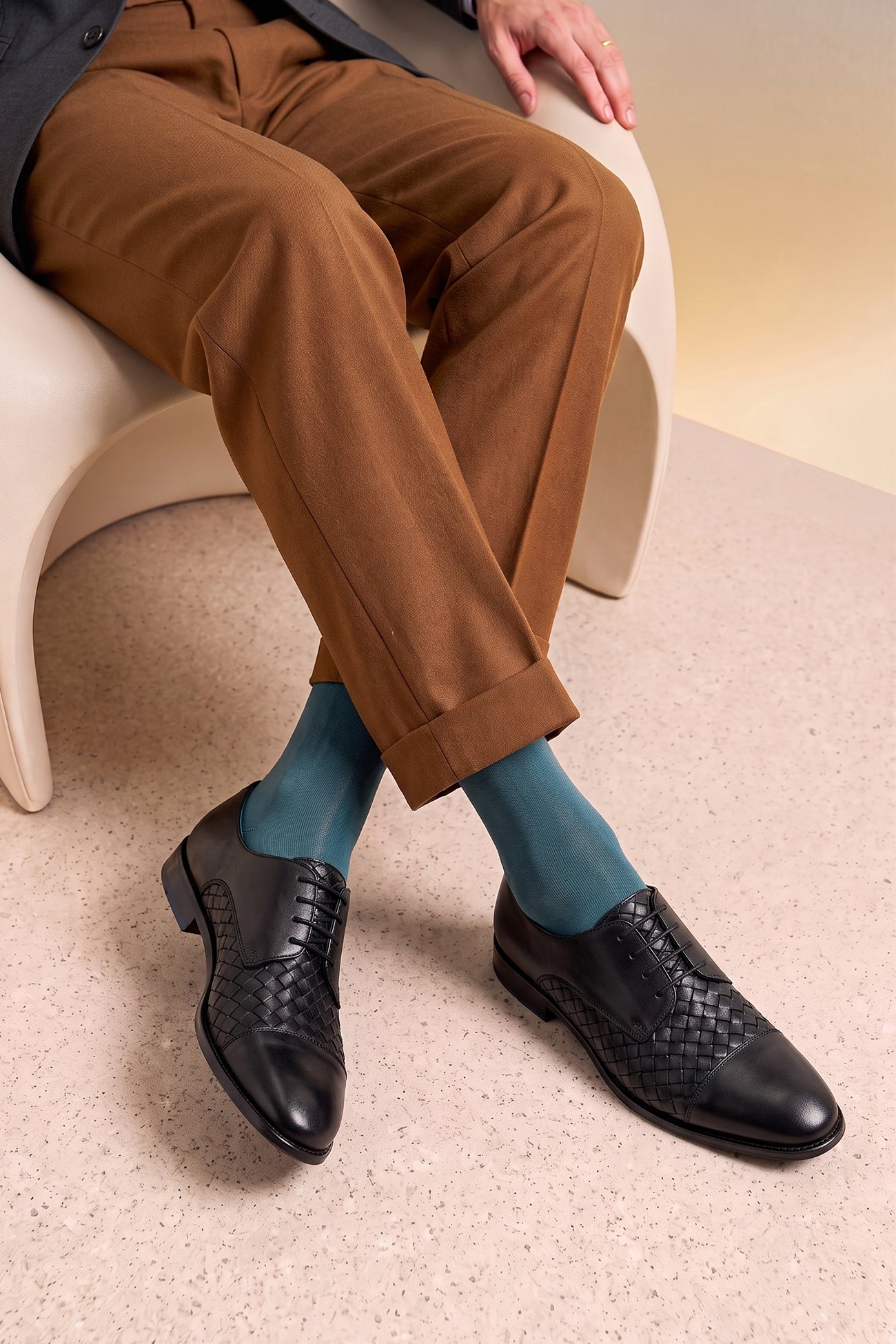 Model wearing Heath black woven leather derby shoes for men by Oswin Hyde – breathable lace-up shoes with cushioned insole and refined texture for formal or smart casual wear.