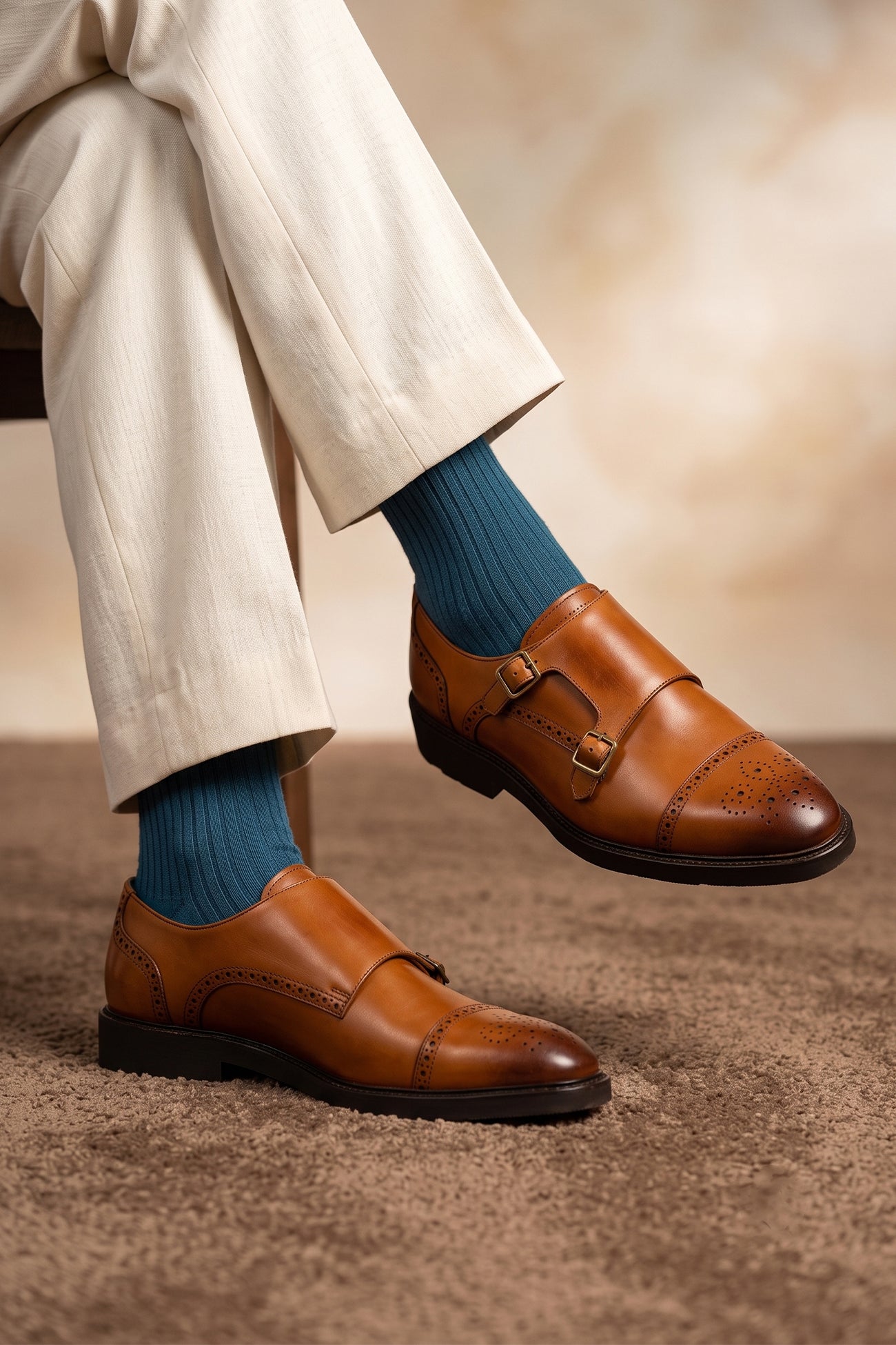 Model wearing Men’s Shelby tan leather monk strap brogue shoes featuring intricate broguing and premium craftsmanship for formal and smart-casual occasions.