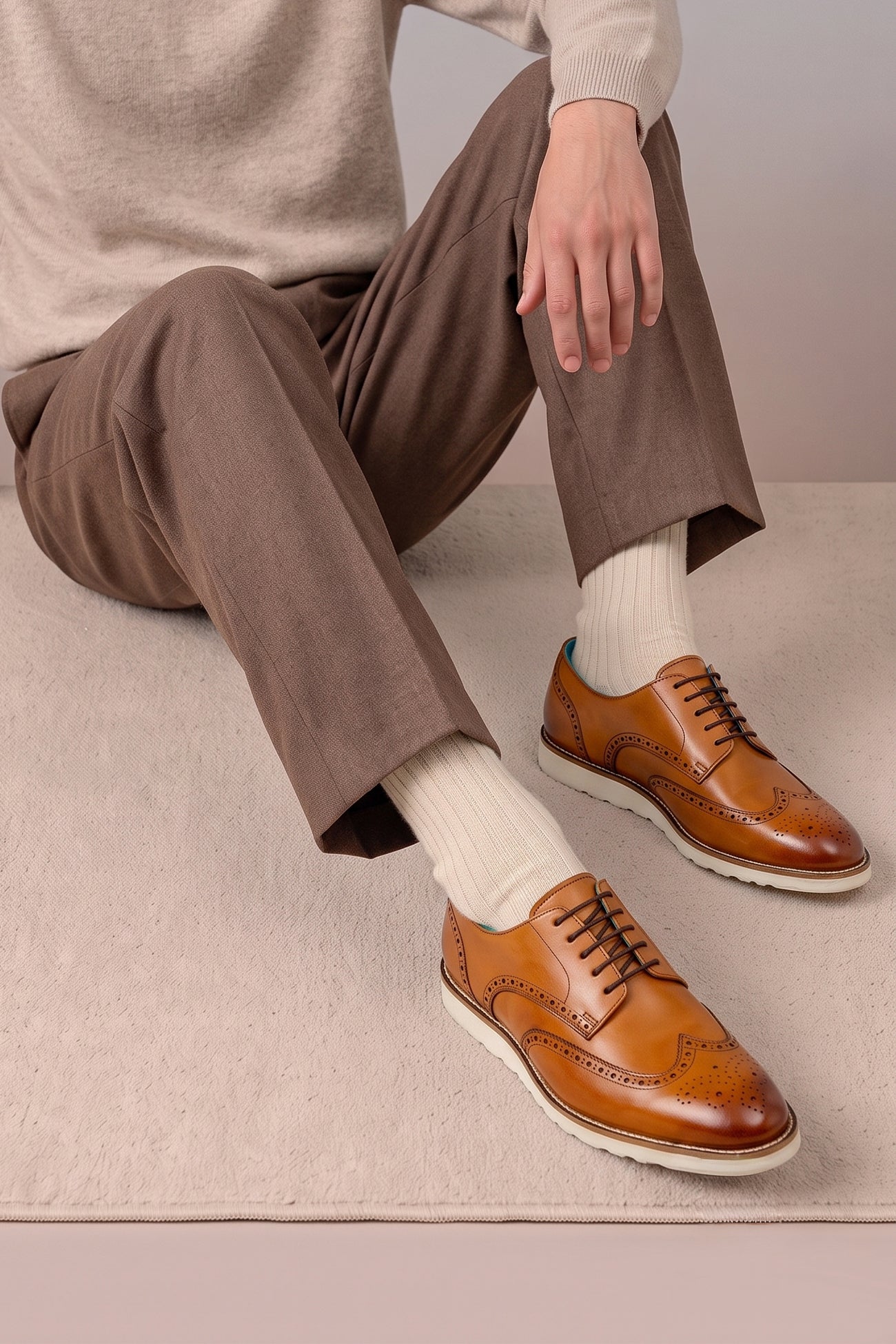 Model wearing Men’s Conner tan leather derby trainers combining classic leather with sporty trainer design for versatile casual and smart looks.