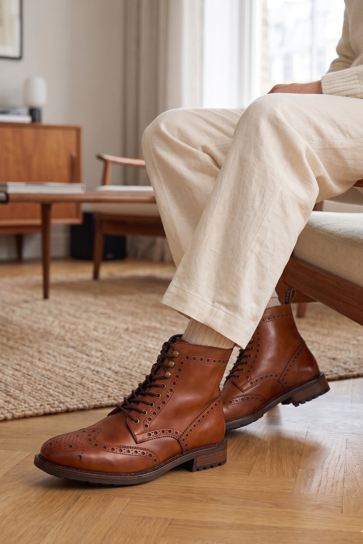 Man wearing Gregory Tan leather boot with brogue details, wingtip boots for men, tan leather walking boots.