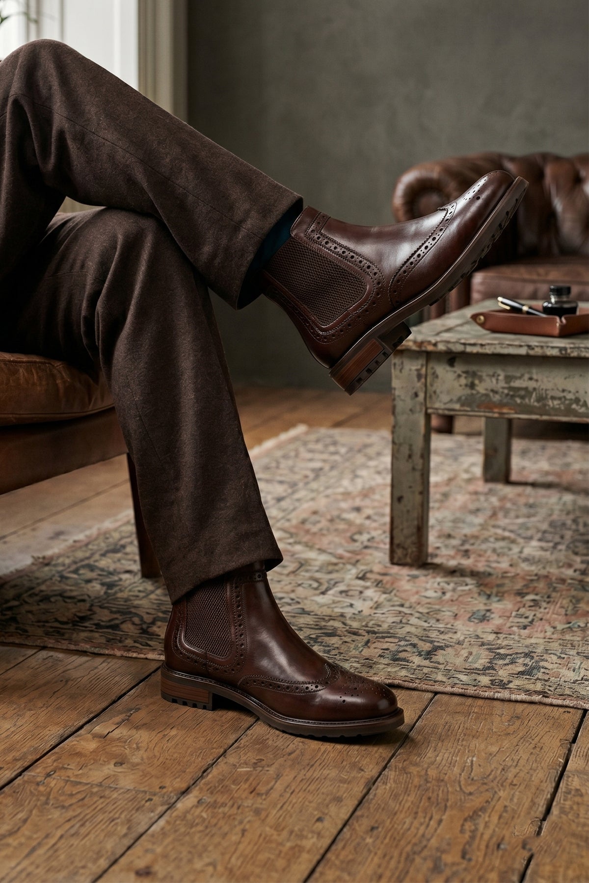 Man wearing Gavin Brown leather Chelsea boots for men featuring a classic wing cap brogue design with refined stitching and polished finish