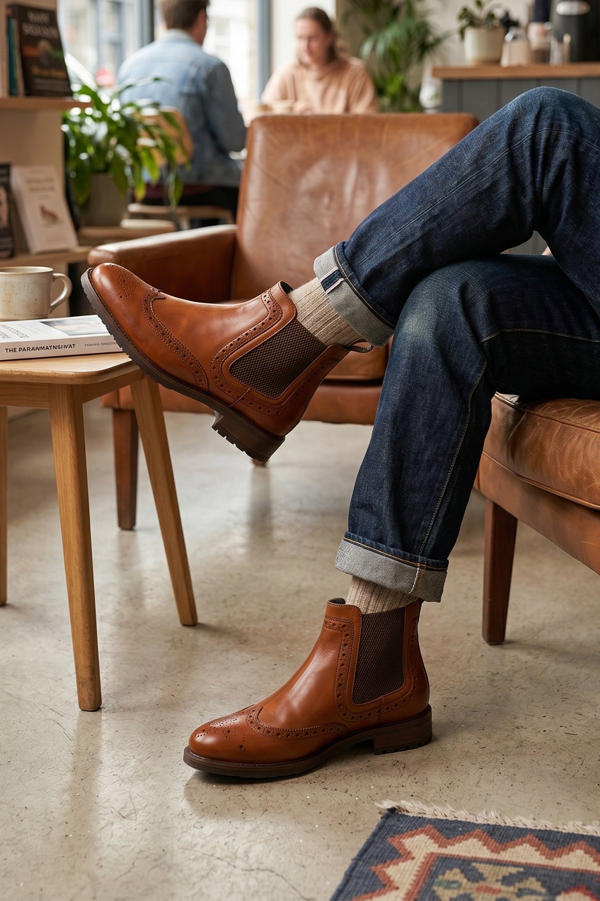 Man wearing Gavin Tan leather Chelsea boots for men featuring a classic wing cap brogue design with refined stitching and polished finish
