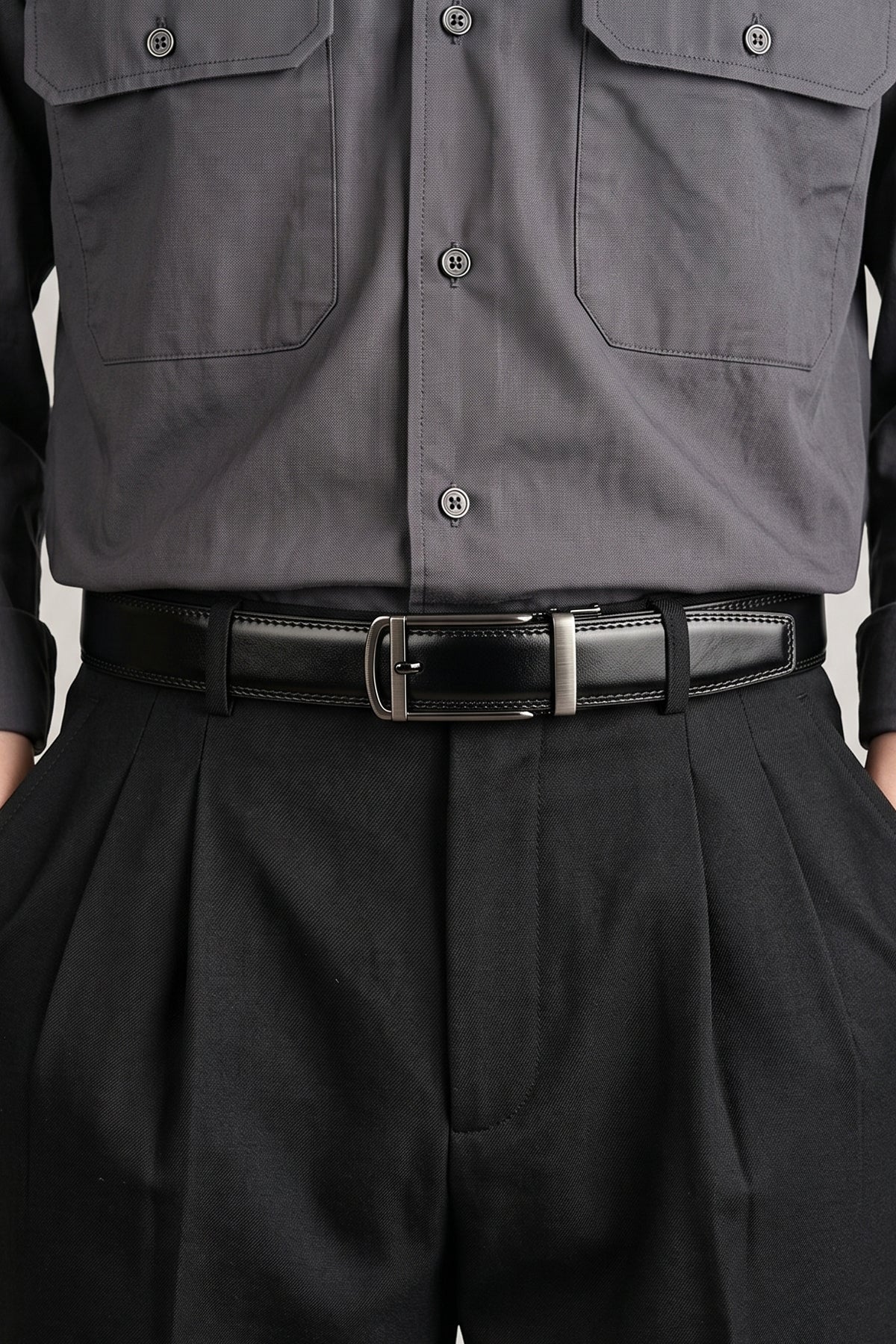 Man wearing Men’s Nelson black premium leather automatic belt with ratchet mechanism, offering adjustable fit and sleek style for formal and casual outfits.