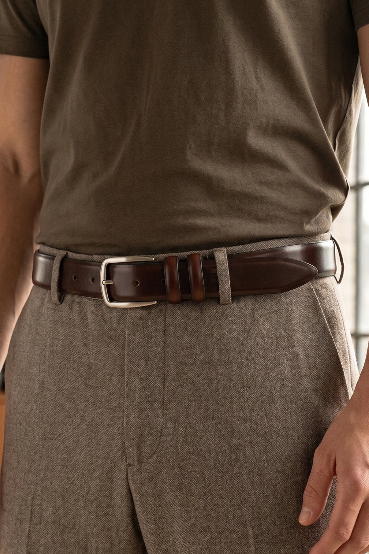 Man wearing Gavin Brown leather belt with a silver buckle on a beige background