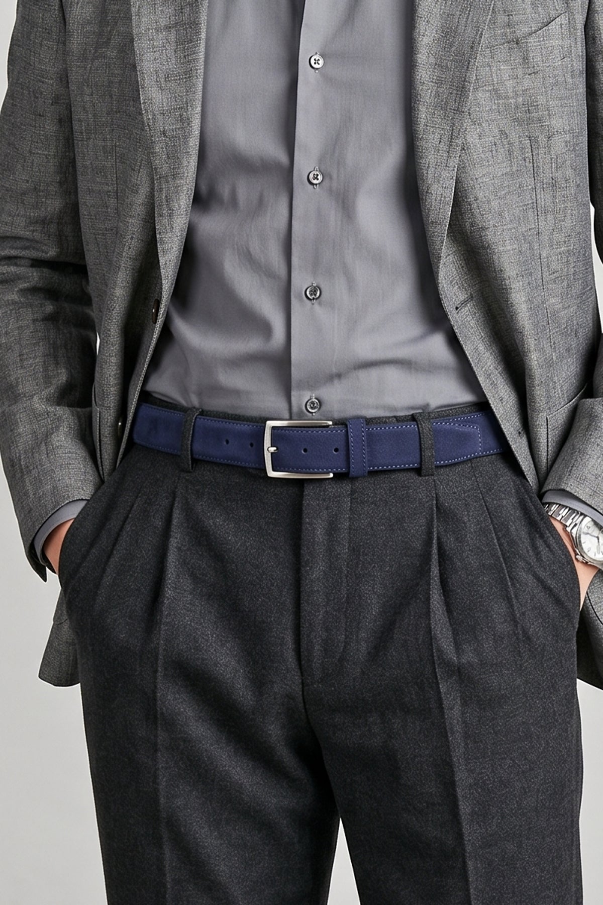 Man wearing Kenneth Navy suede leather belt for men. Featuring a classic pin buckle, this belt combines style and durability with a soft suede finish.