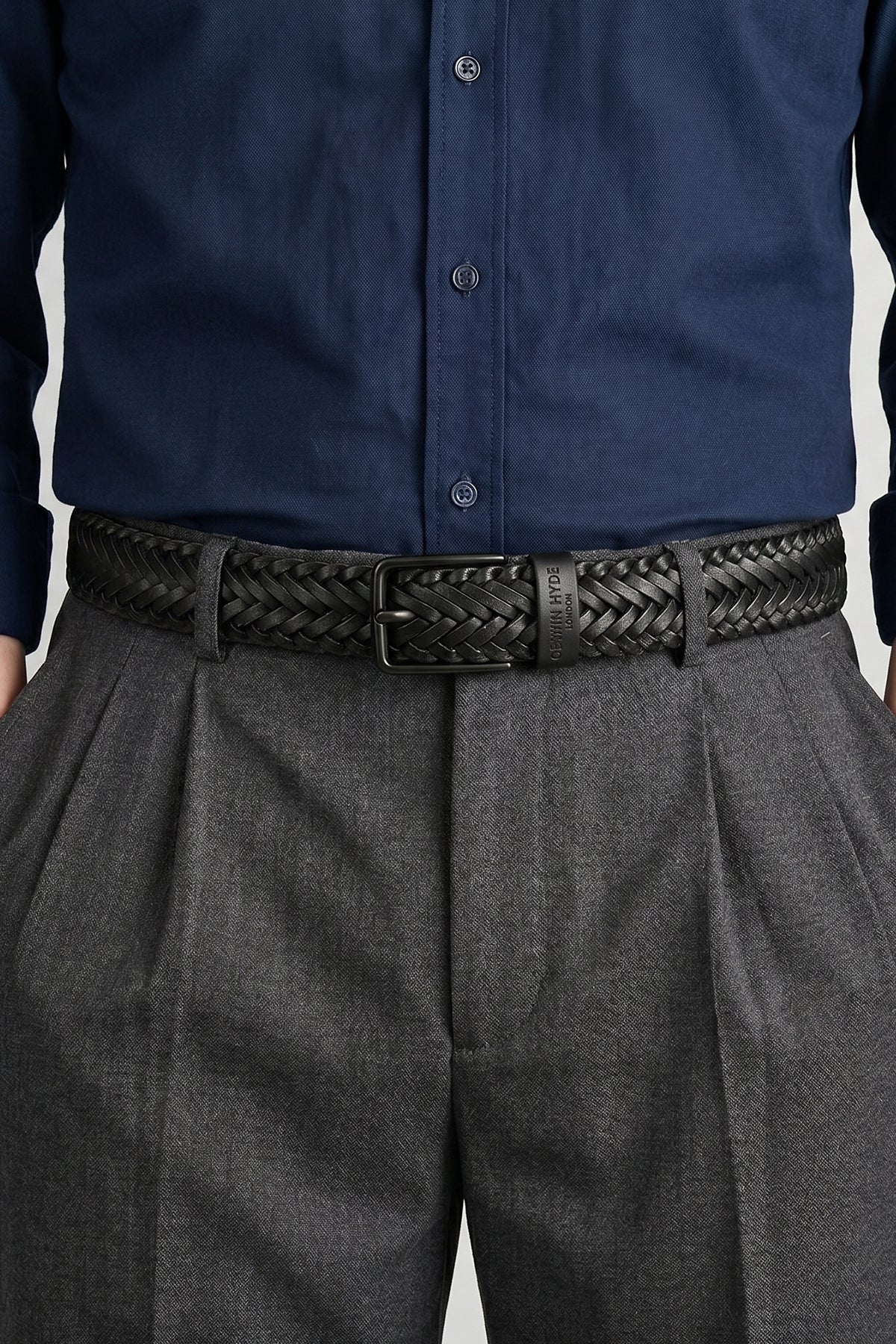 Man wearing Milo black braided leather belt for men by Oswin Hyde – luxury woven leather accessory with silver buckle for elegant, versatile everyday and formal wear.