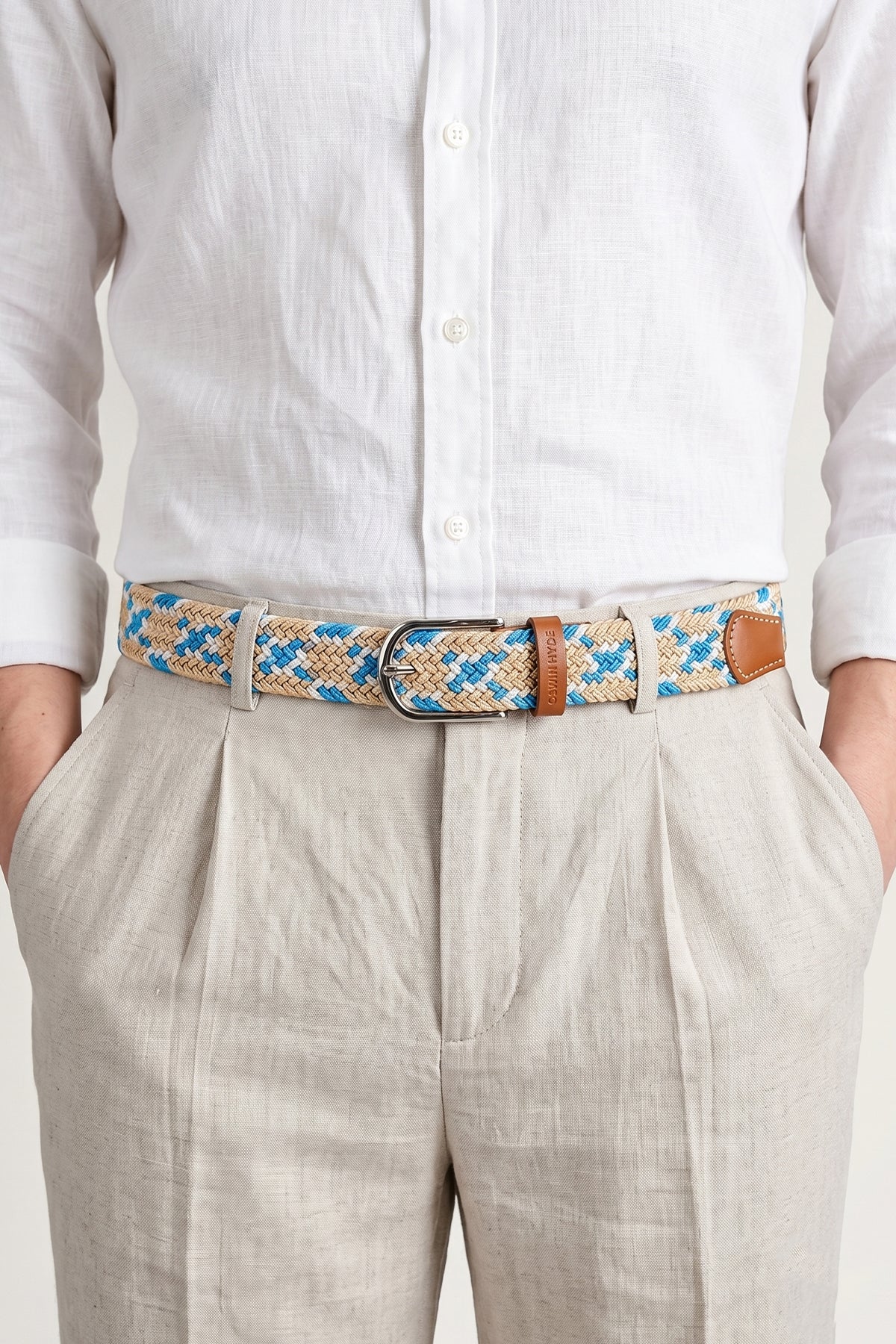 Man wearing Oswin Hyde Guy Beige belt - Braided elastic in neutral tones for smart-casual wear