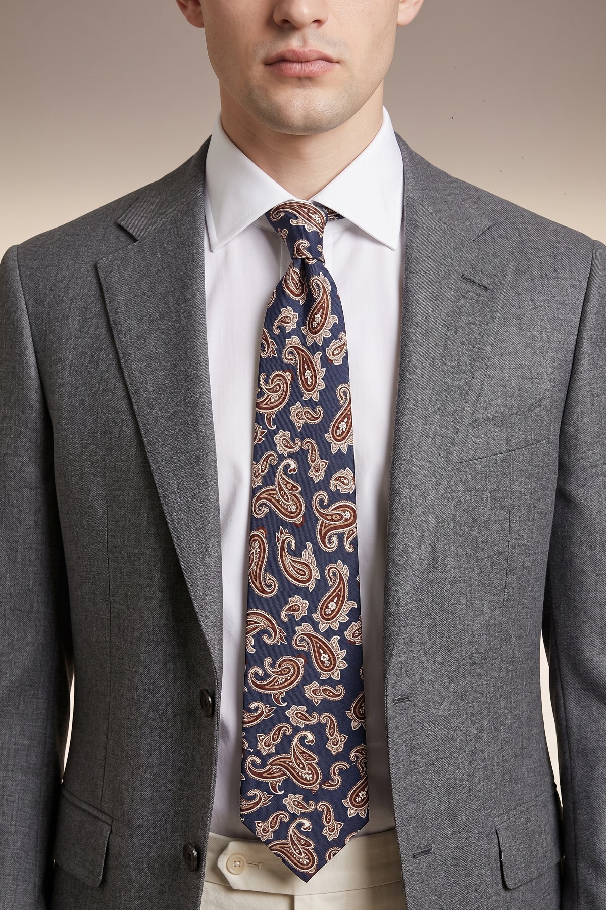 Man wearing Navy Paisley Silk Tie with paisley design, offering luxury and elegance for special occasions.