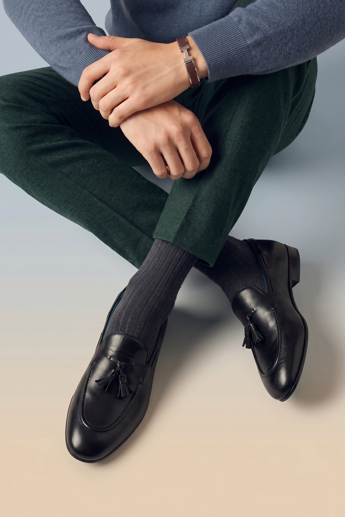 Model wearing Alvin Black leather tassel loafers for men crafted from premium leather with classic tassel detail, ideal for formal and smart casual occasions.