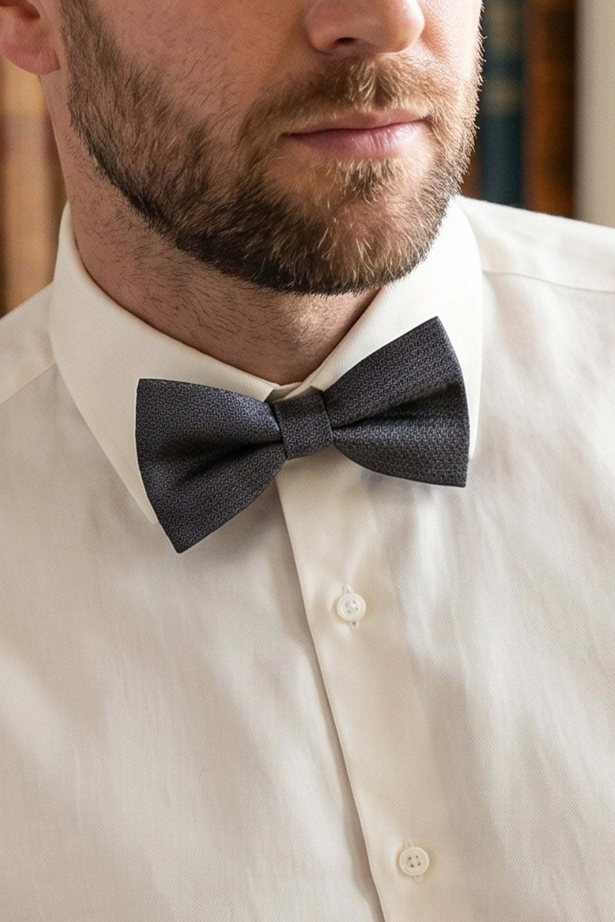 Man wearing Oswin Hyde Black Gray Scotch Texture Bowtie for men, designed with a distinctive scotch-textured pattern