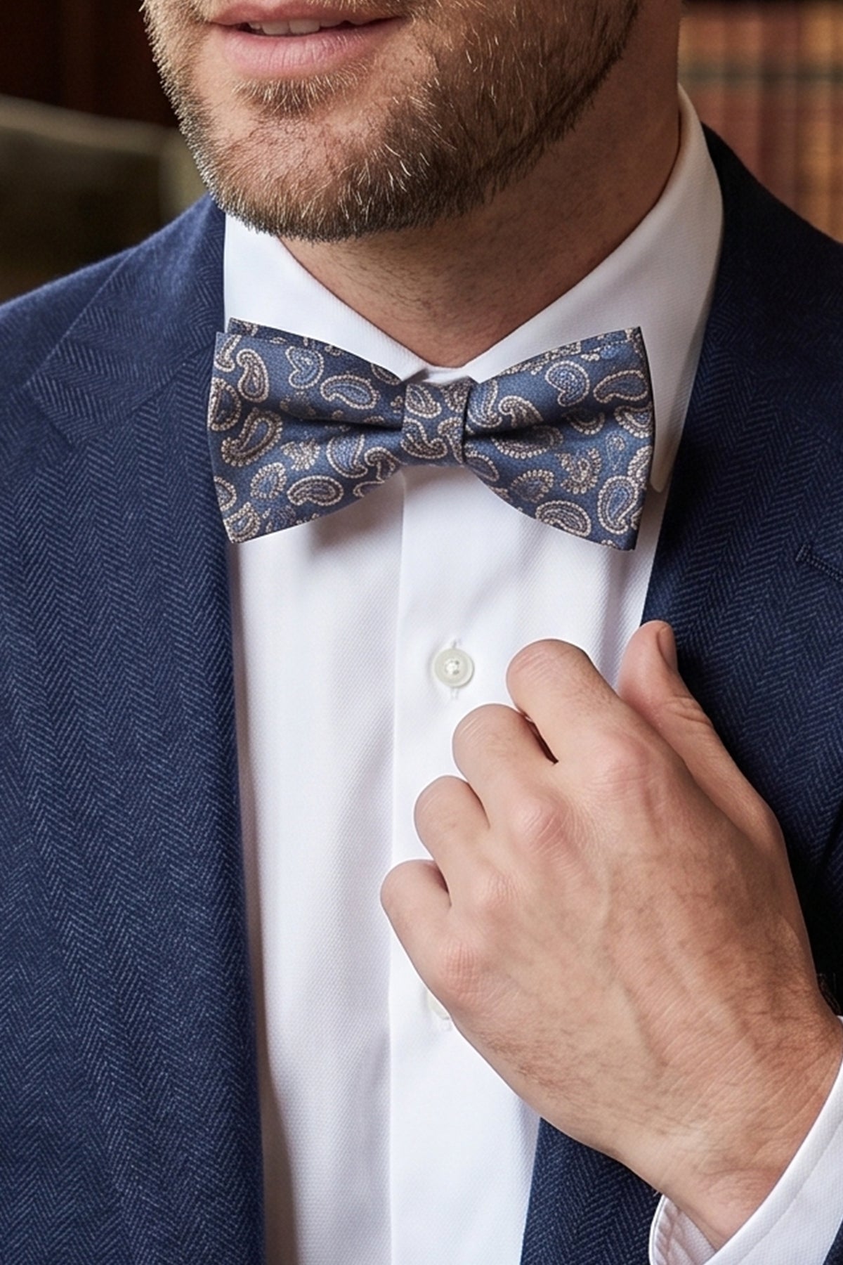 Man wearing Paisley Pattern Navy bowtie for men, rich navy colour and detailed pattern make it an elegant choice for weddings.
