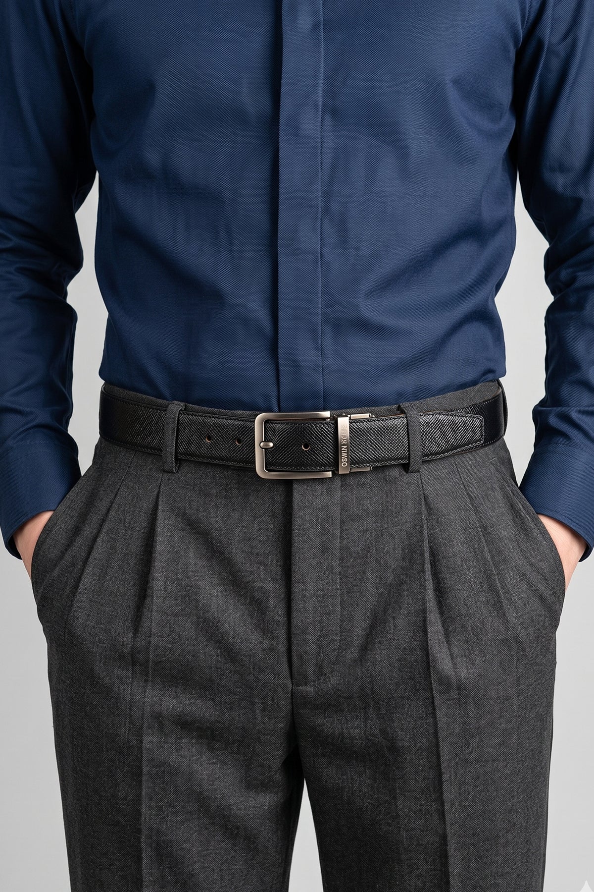 Men’s Claud reversible belt in black and navy premium leather with a sleek polished buckle, designed for versatile and sophisticated styling.