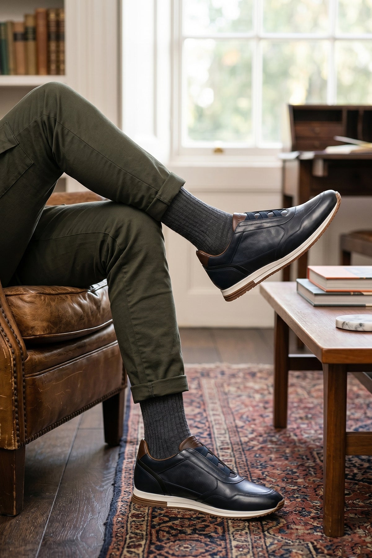 Model wearing Colt Navy men's leather sneakers, featuring a clever elastic design that ensures a comfortable and secure fit.