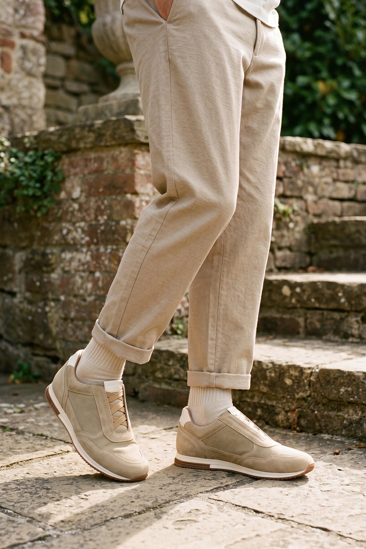 Model wearing Colt sand suede men’s sneakers with elastic sides, premium leather finish, and casual lightweight sole for everyday wear.