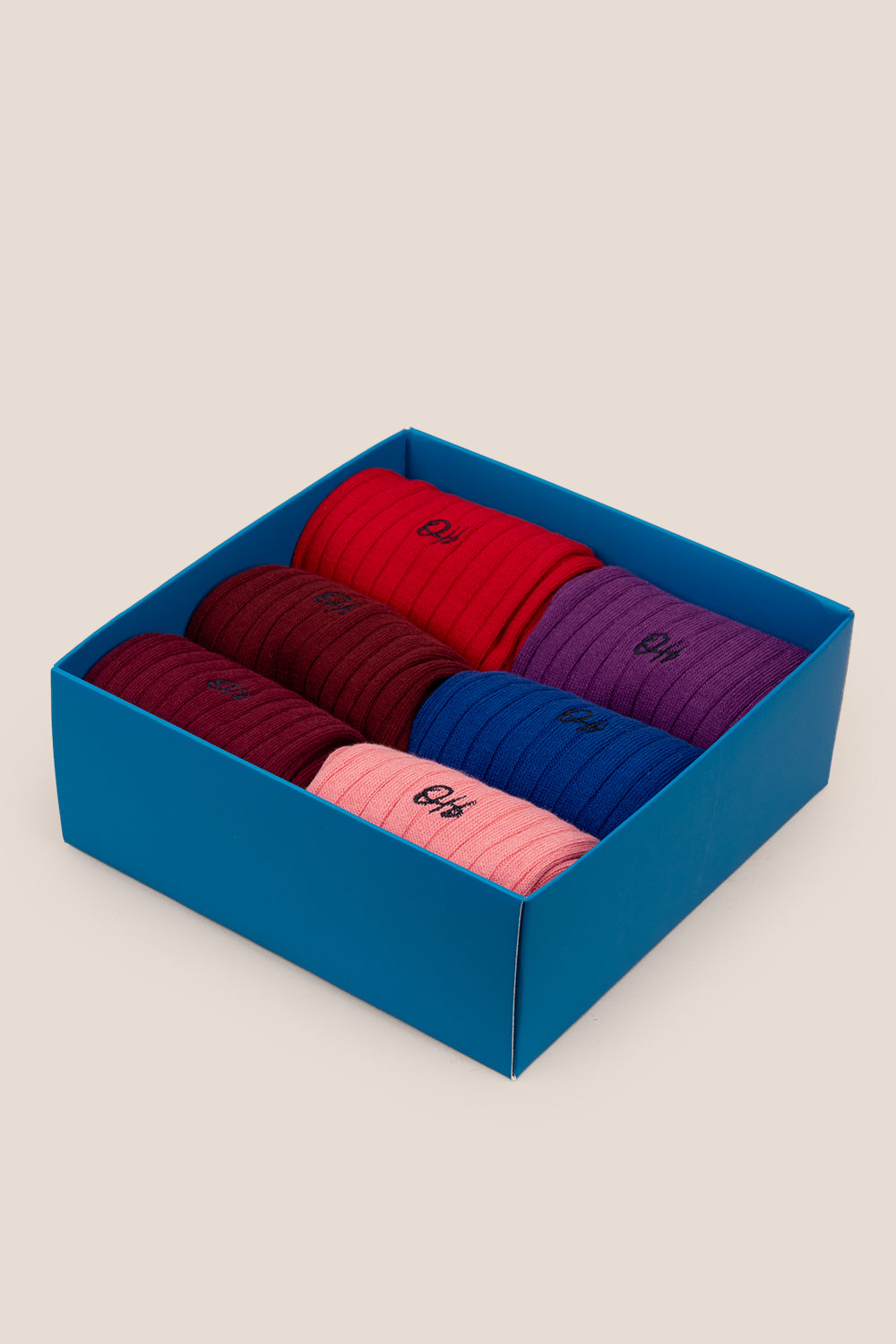 Oswin Hyde Groovy Six premium socks in bold reds, blues, and pinks, packaged in a sleek box for stylish gifting