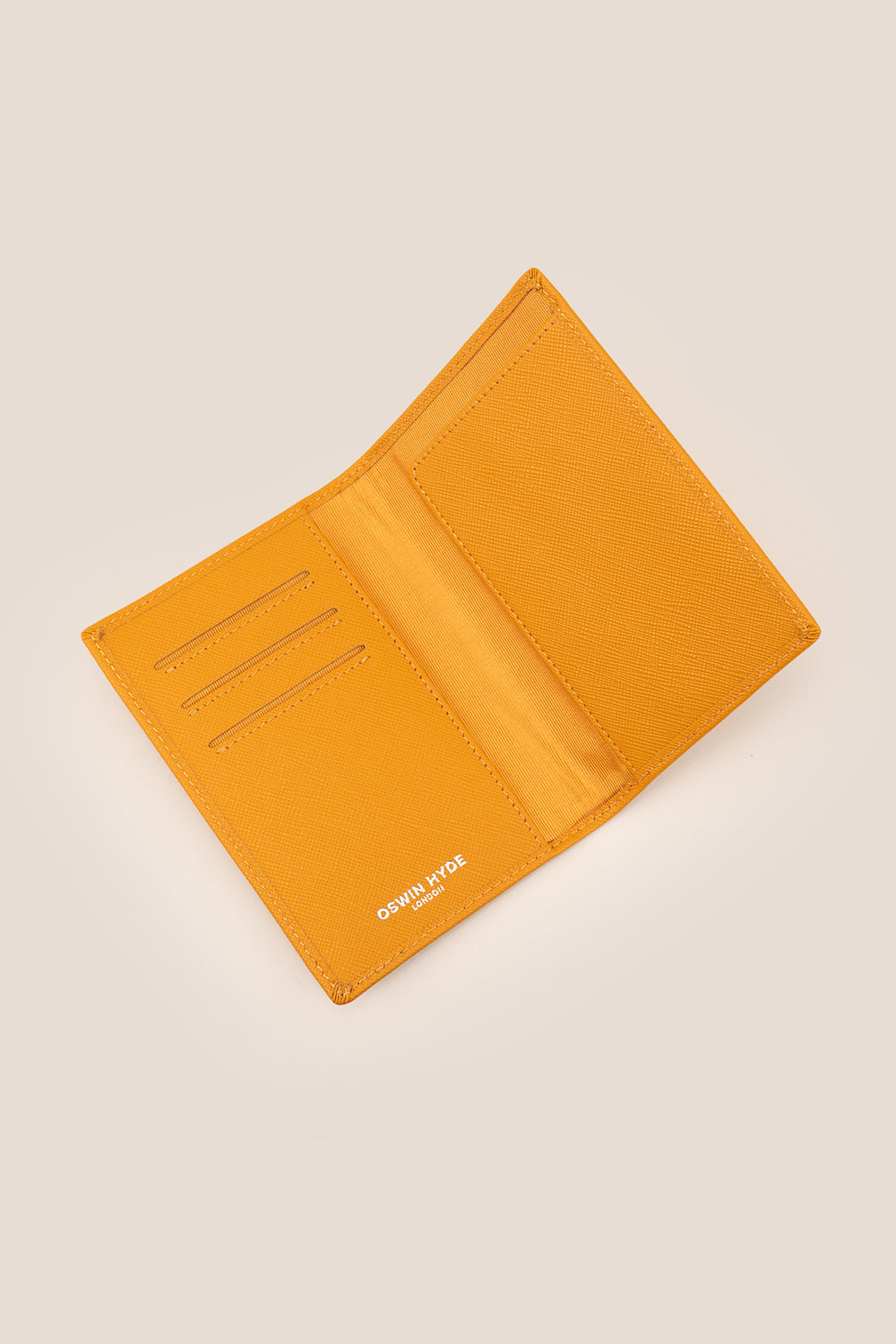 Tan saffiano leather men’s passport holder by Oswin Hyde – slim and stylish travel accessory with secure slot and textured finish.