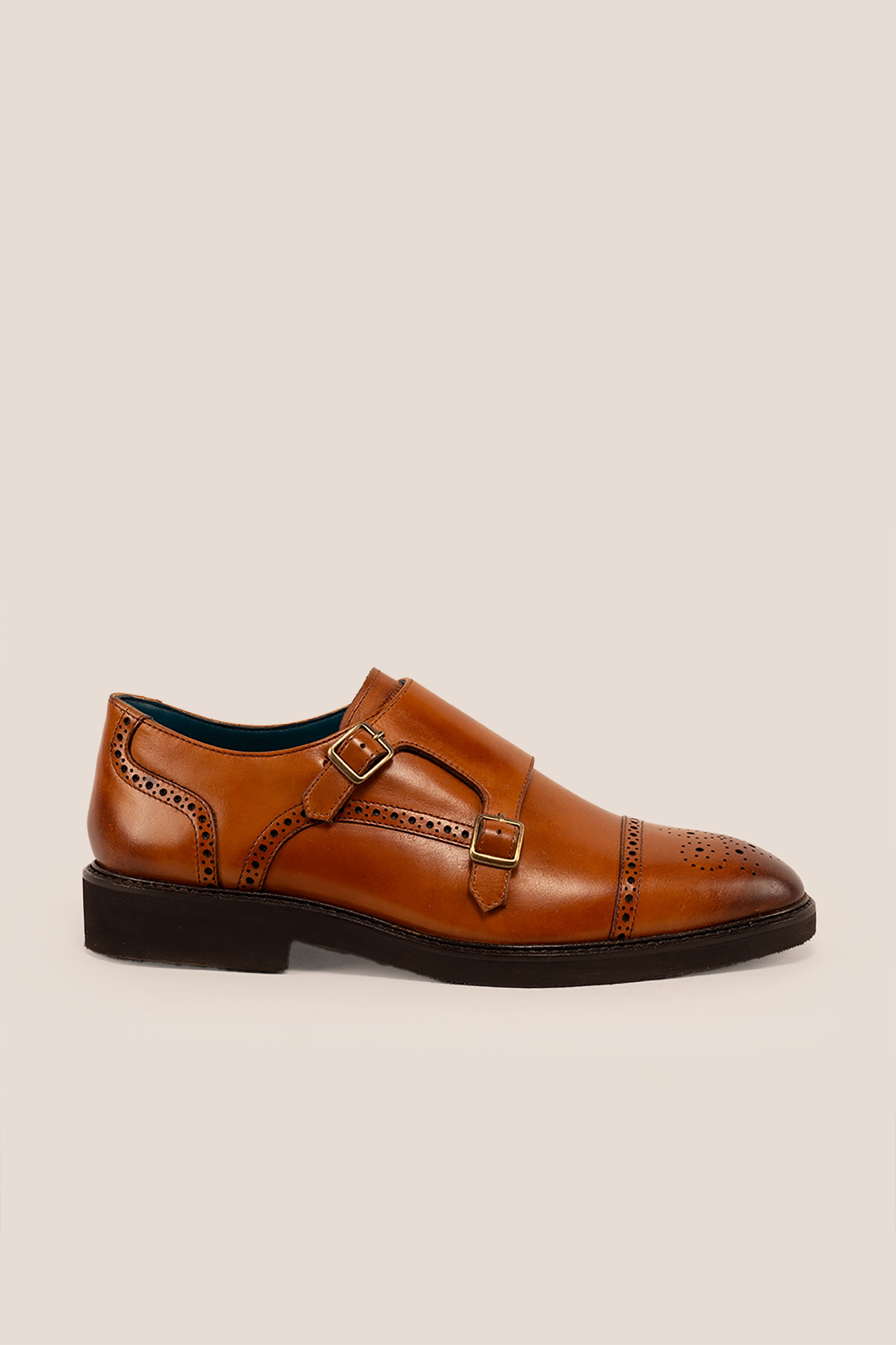 Men’s Shelby tan leather monk strap brogue shoes featuring intricate broguing and premium craftsmanship for formal and smart-casual occasions.