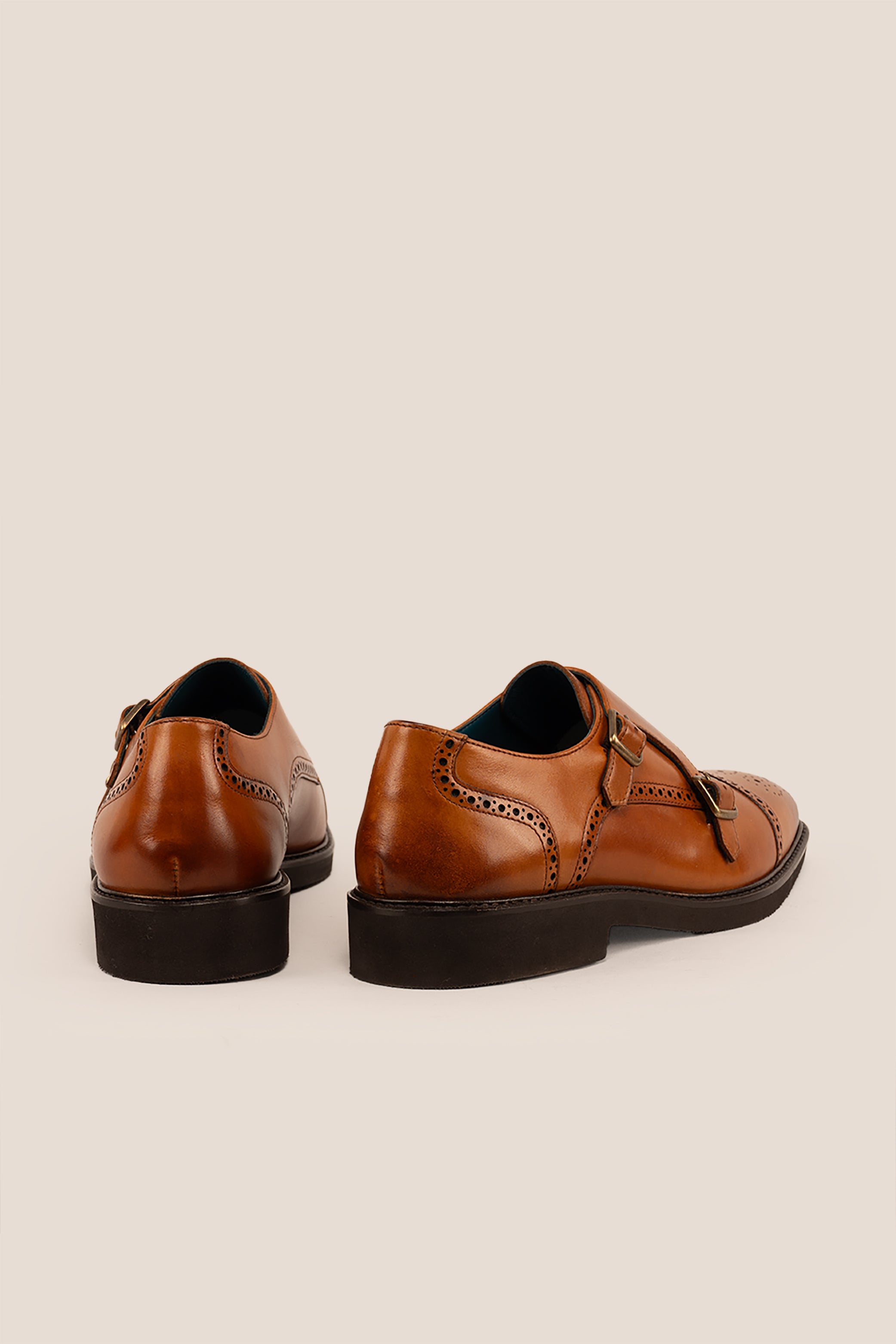 Men’s Shelby tan leather monk strap brogue shoes featuring intricate broguing and premium craftsmanship for formal and smart-casual occasions.