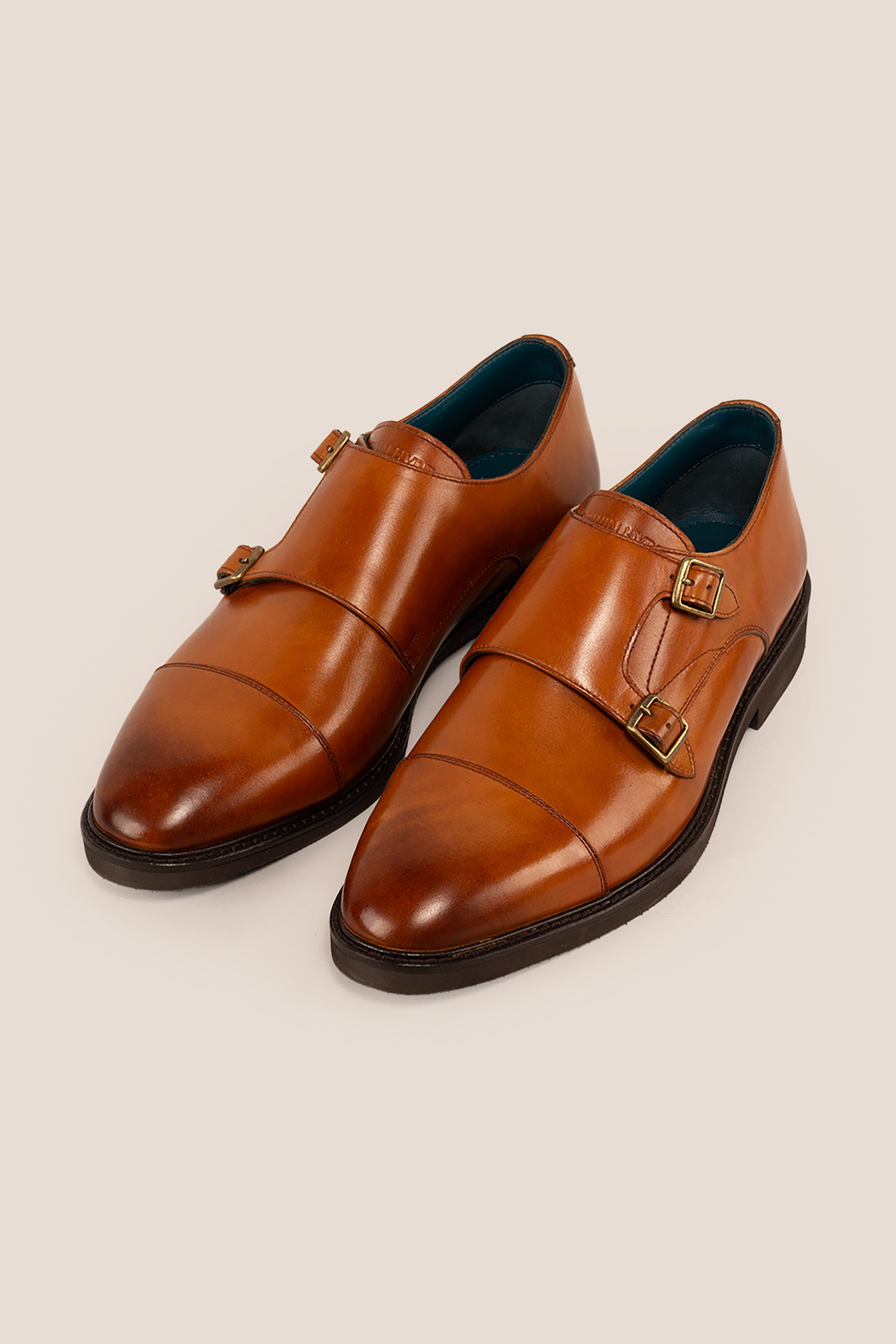 Garson tan monk strap leather men’s shoes with premium craftsmanship, sleek design, and classic buckle detail for formal and office wear.