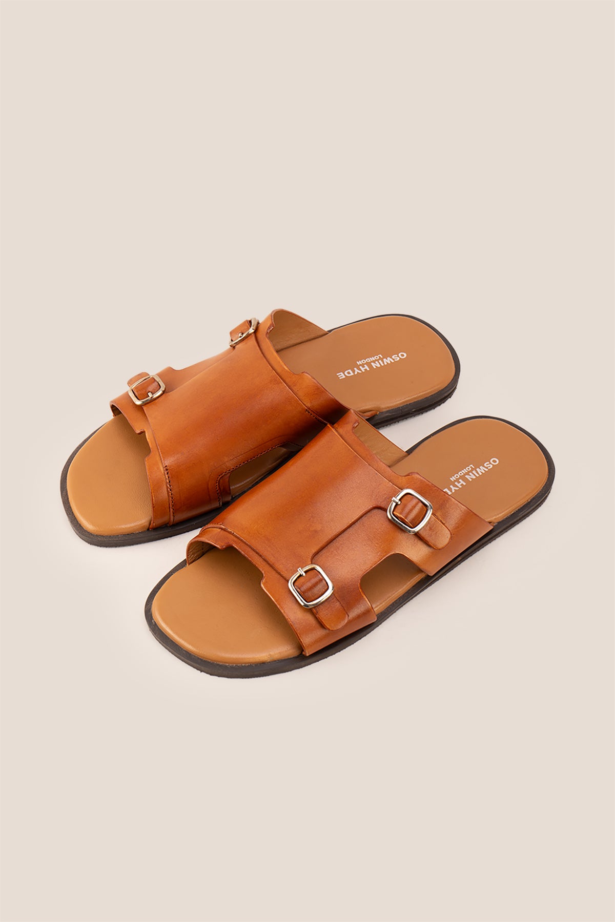 Logan tan leather sandals for men made from premium leather with open-toe design and stitched sole, ideal for summer comfort and smart-casual wear.