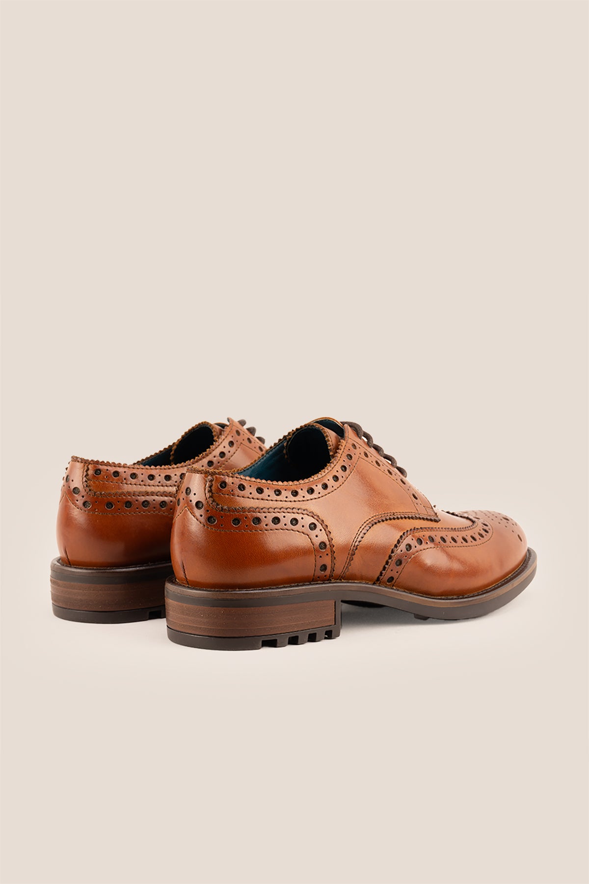 George Tan leather shoes for men. Featuring a five-eyelet wing cap brogue design, these shoes offer timeless style and comfort