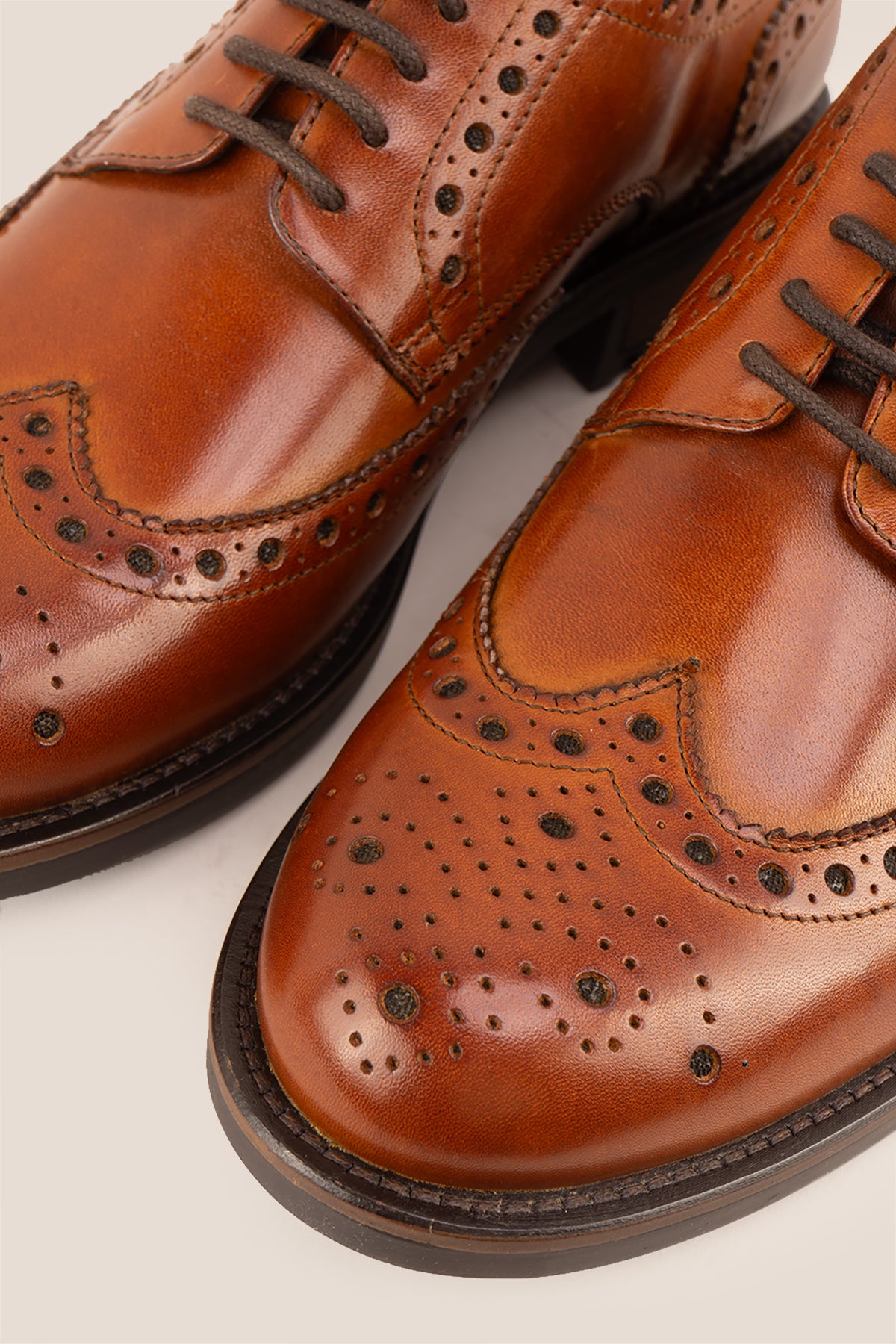 George Tan leather shoes for men. Featuring a five-eyelet wing cap brogue design, these shoes offer timeless style and comfort