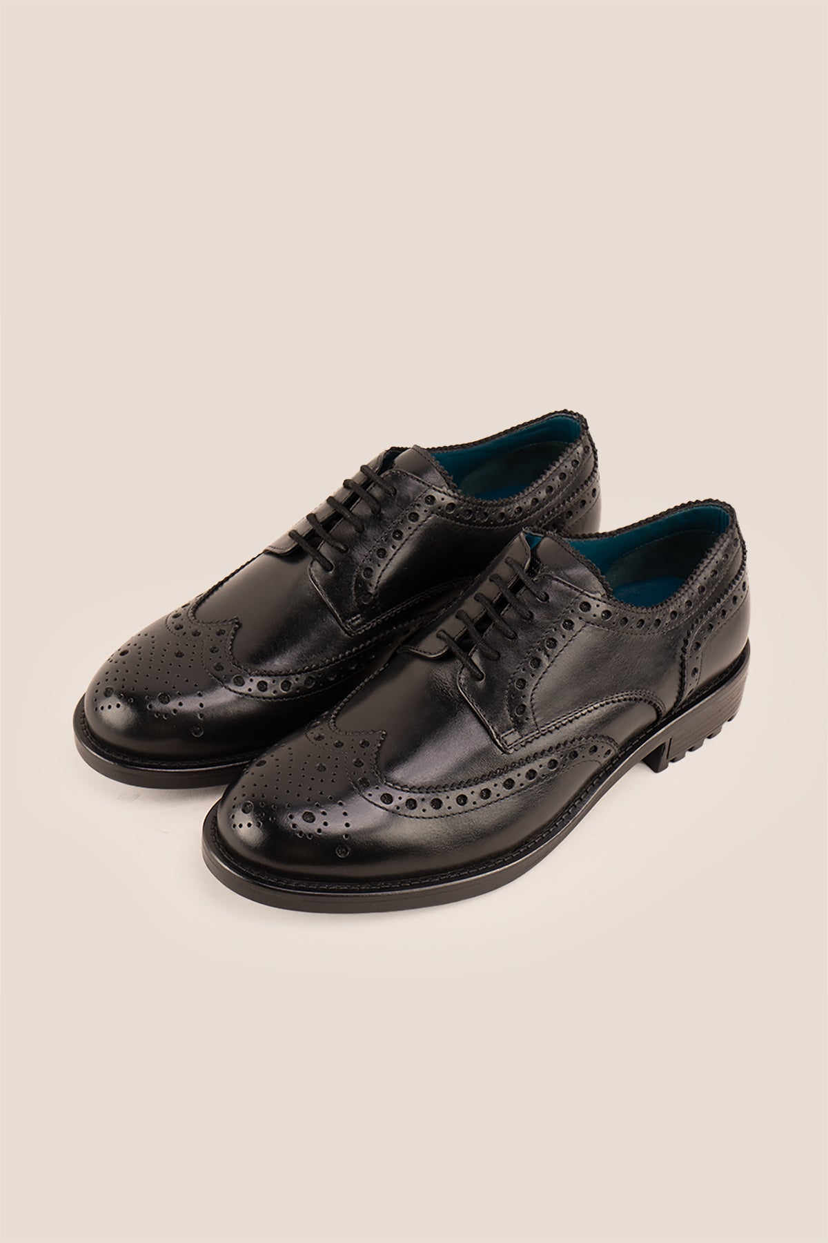 George Black leather shoes for men. Featuring a five-eyelet wing cap brogue design, these shoes offer timeless style and comfort