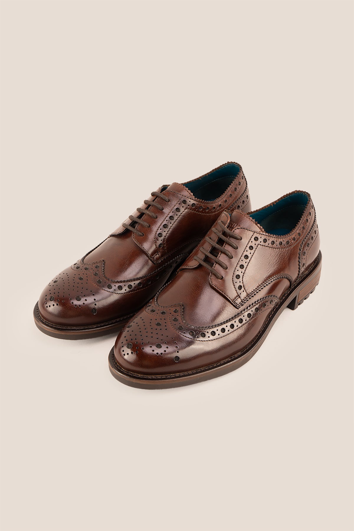 George Brown leather shoes for men. Featuring a five-eyelet wing cap brogue design, these shoes offer timeless style and comfort