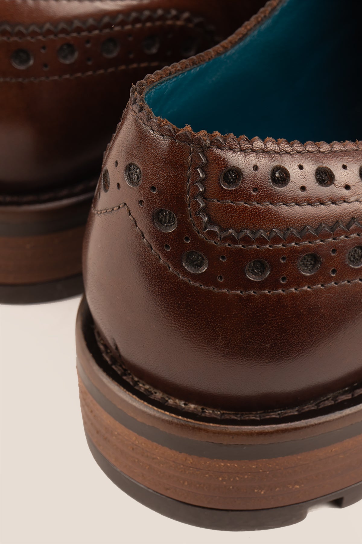 George Brown leather shoes for men. Featuring a five-eyelet wing cap brogue design, these shoes offer timeless style and comfort
