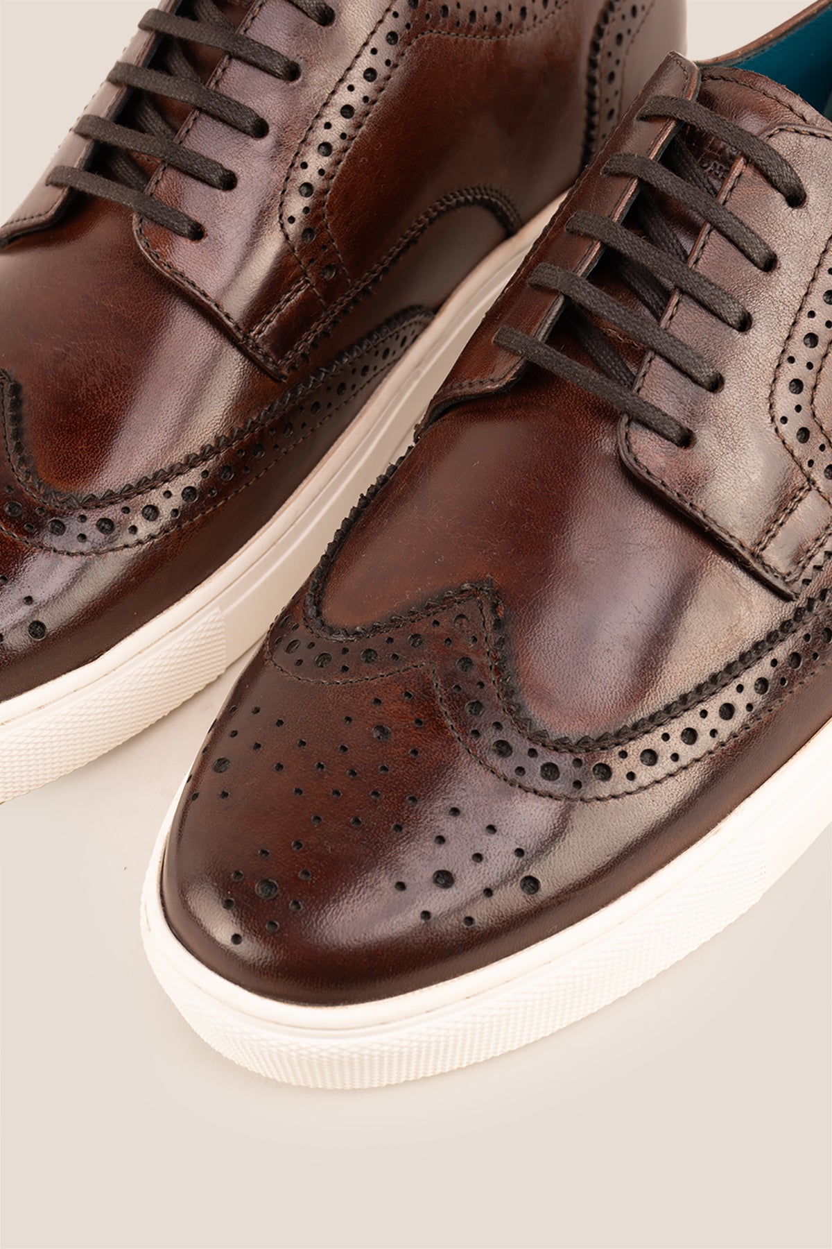 Stan Brown wingtip brogue trainer shoes for men, crafted from premium leather with classic wingtip detailing and modern trainer sole.