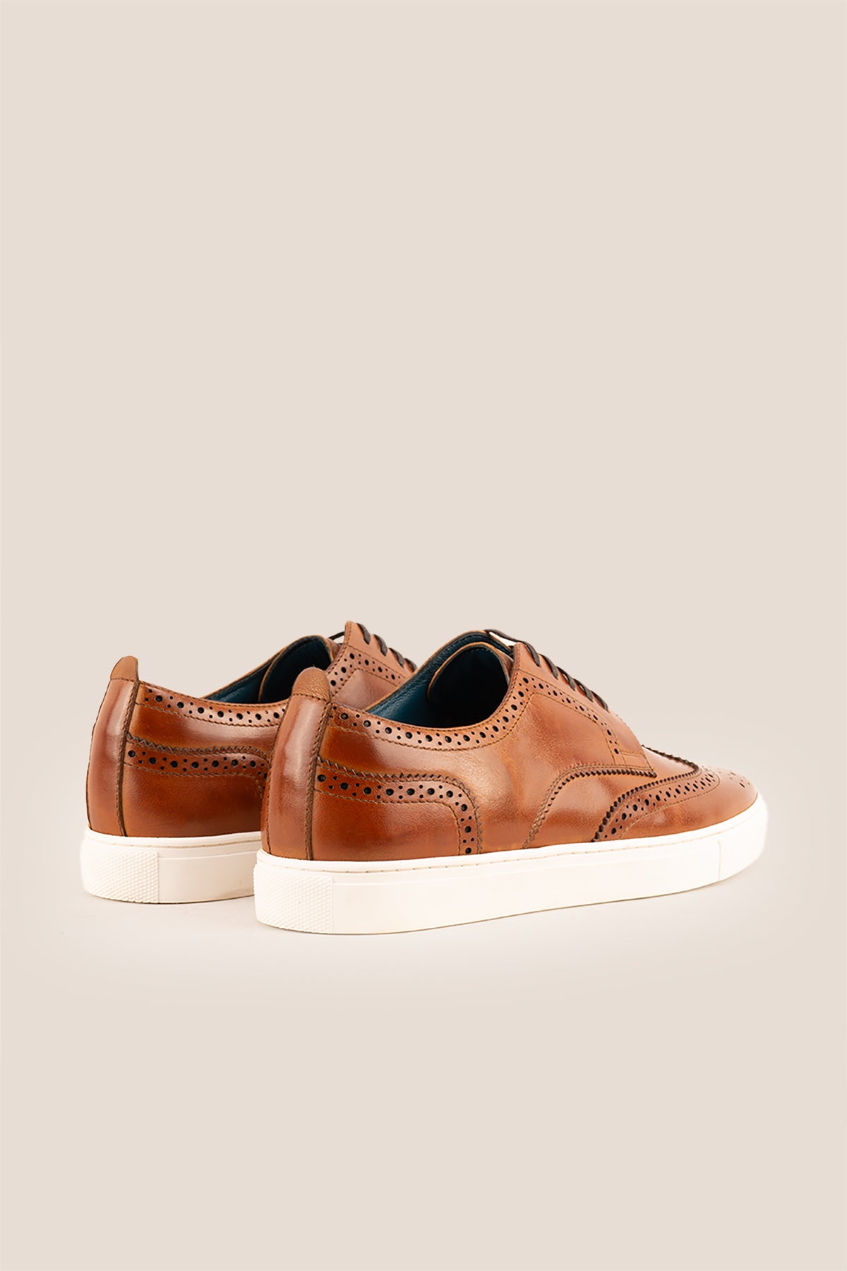 Men’s Stan cognac leather wingtip brogues featuring traditional perforated detailing, breathable lining and a durable leather sole.