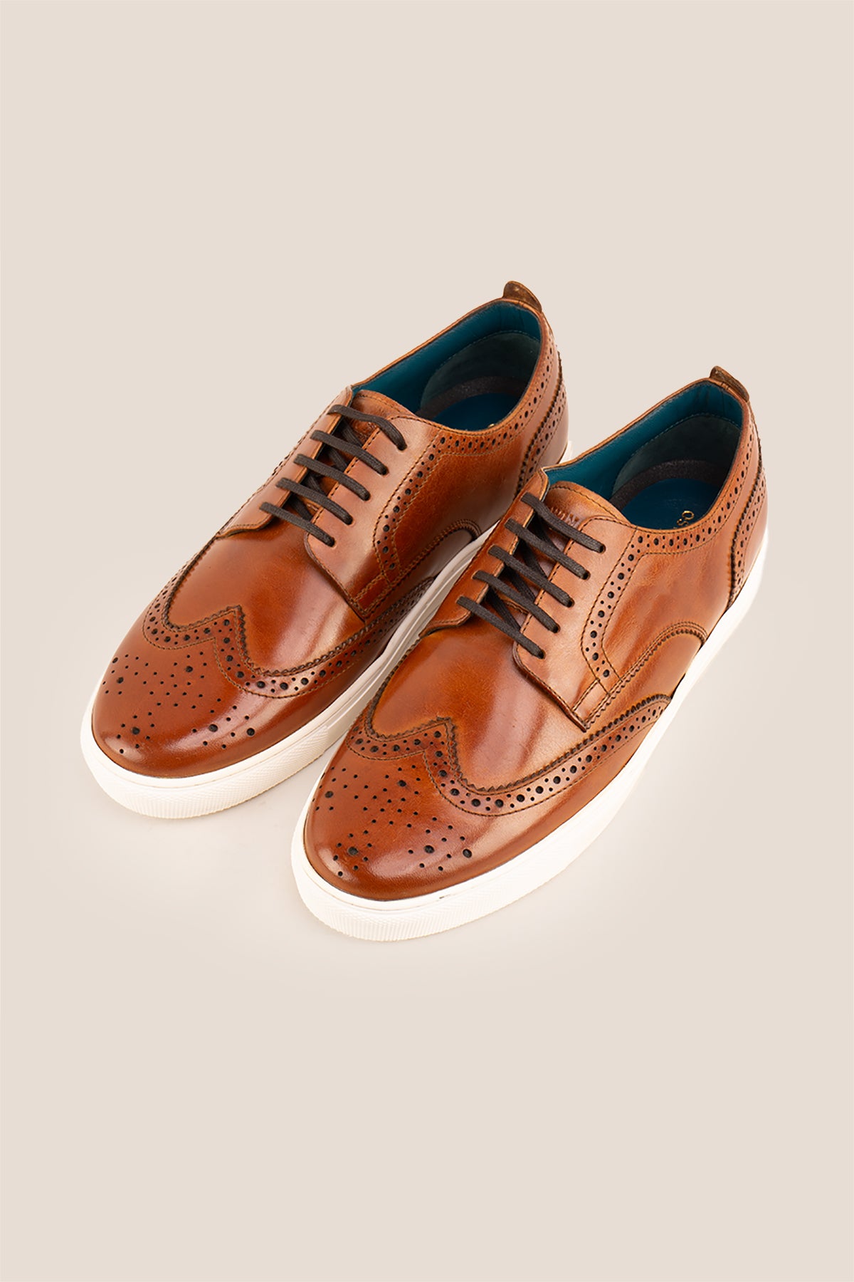 Men’s Stan cognac leather wingtip brogues featuring traditional perforated detailing, breathable lining and a durable leather sole.