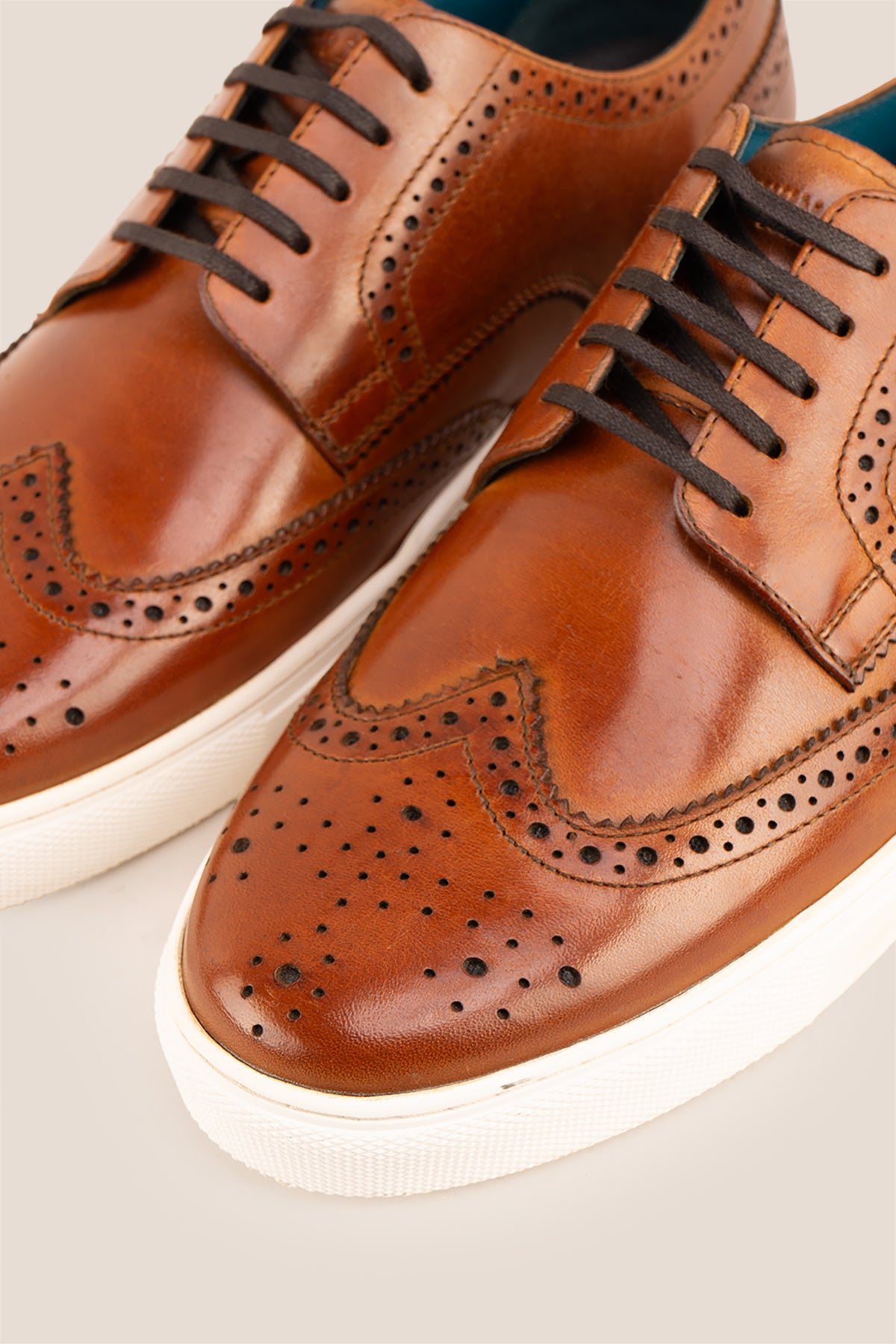 Men’s Stan cognac leather wingtip brogues featuring traditional perforated detailing, breathable lining and a durable leather sole.