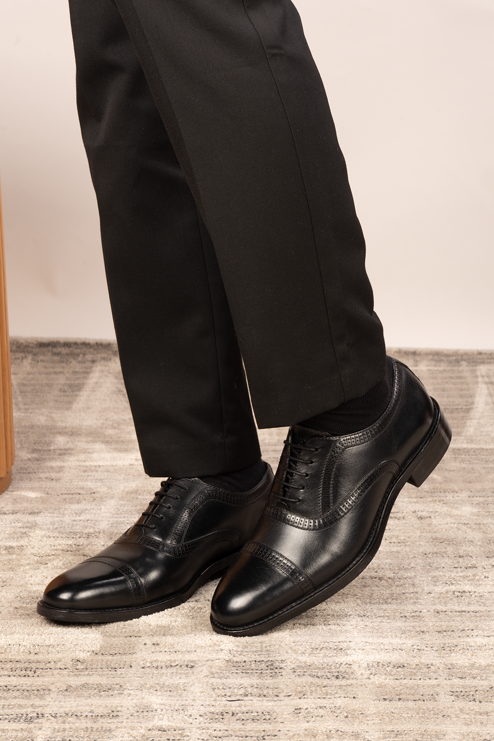 Creed black leather men's brogue shoes with a classic five-eyelet toecap design, featuring polished finish and timeless sophistication