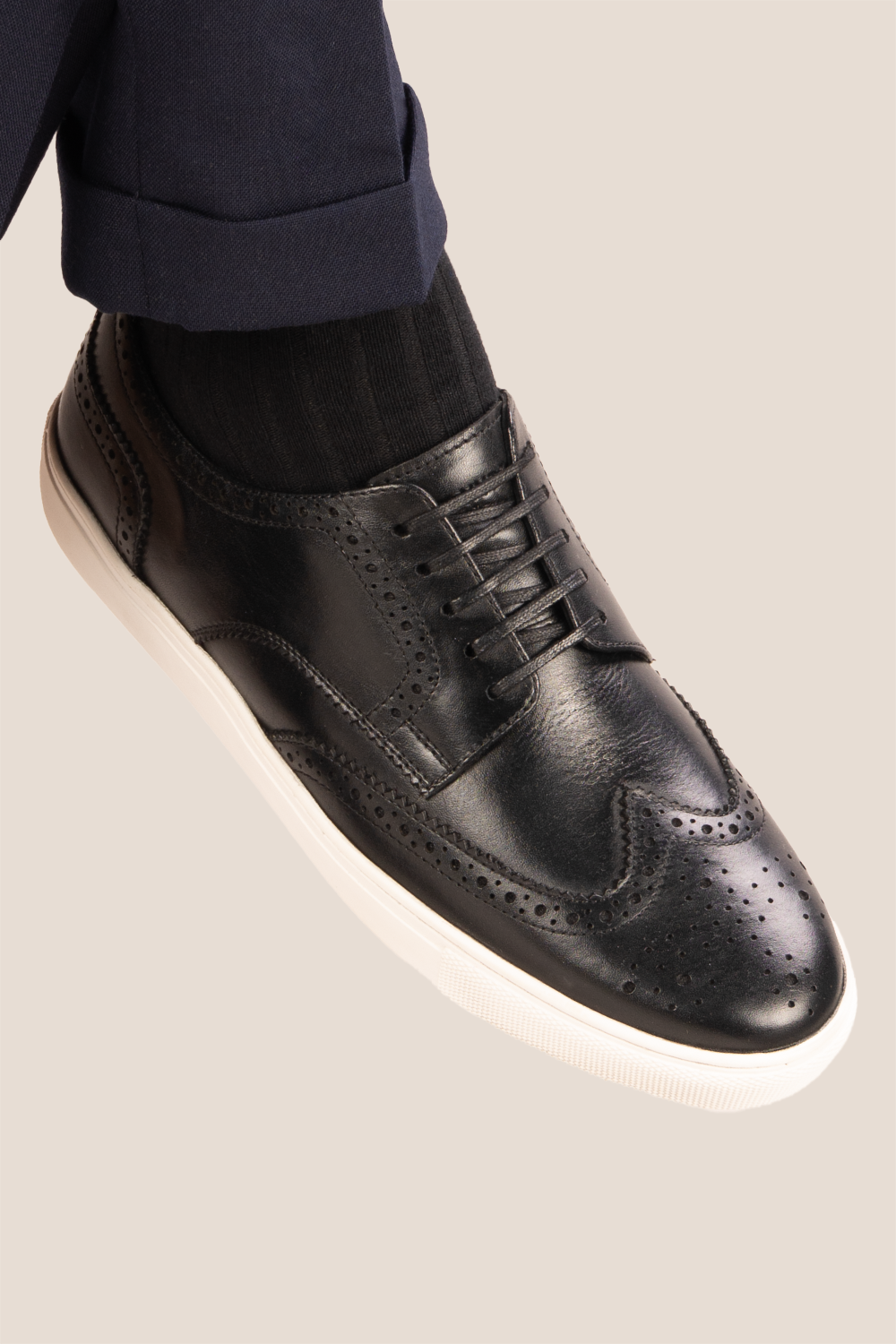 Stan Black wingtip brogue trainer shoes for men, crafted from premium leather with classic wingtip detailing and modern trainer sole.