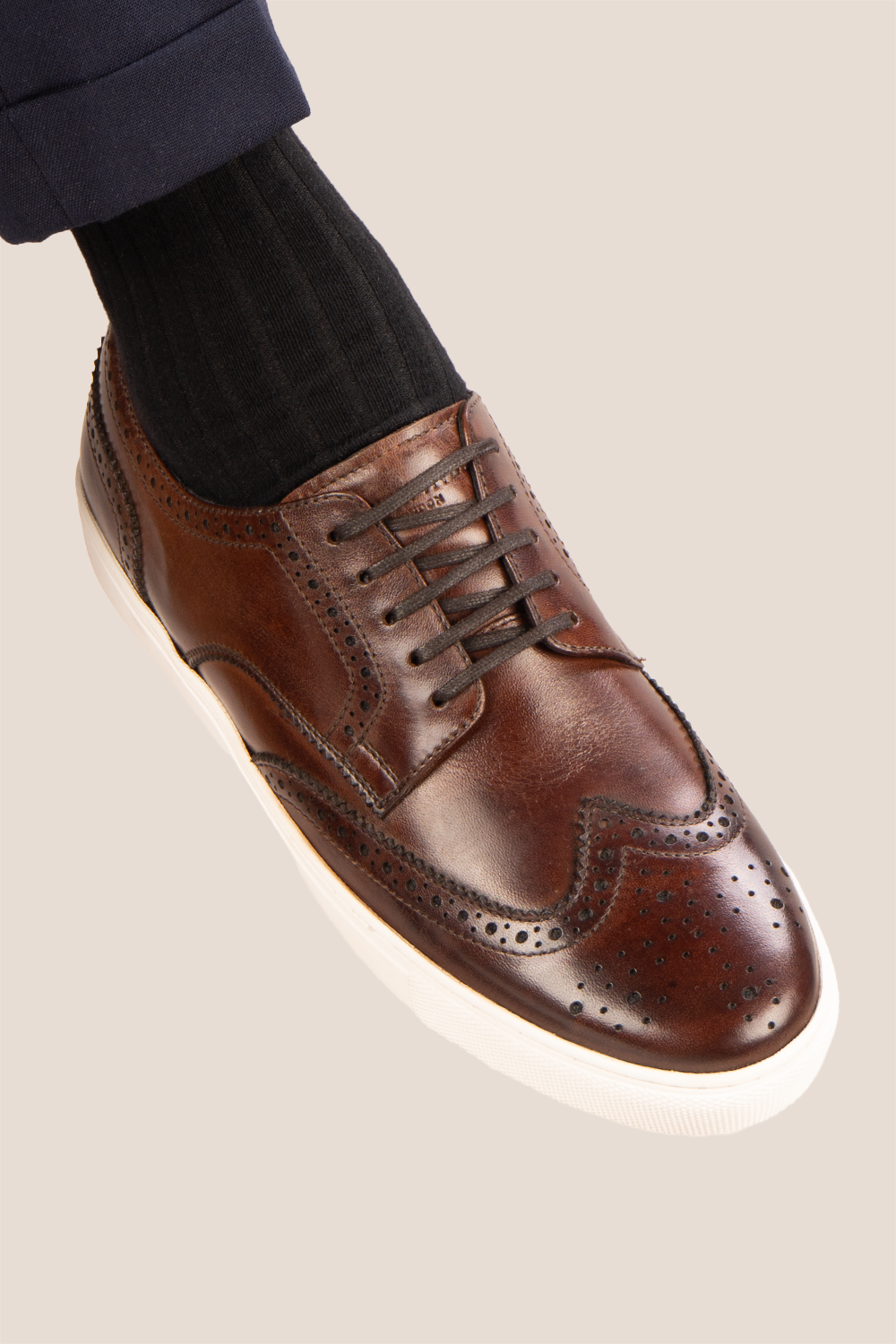 Stan Brown wingtip brogue trainer shoes for men, crafted from premium leather with classic wingtip detailing and modern trainer sole.
