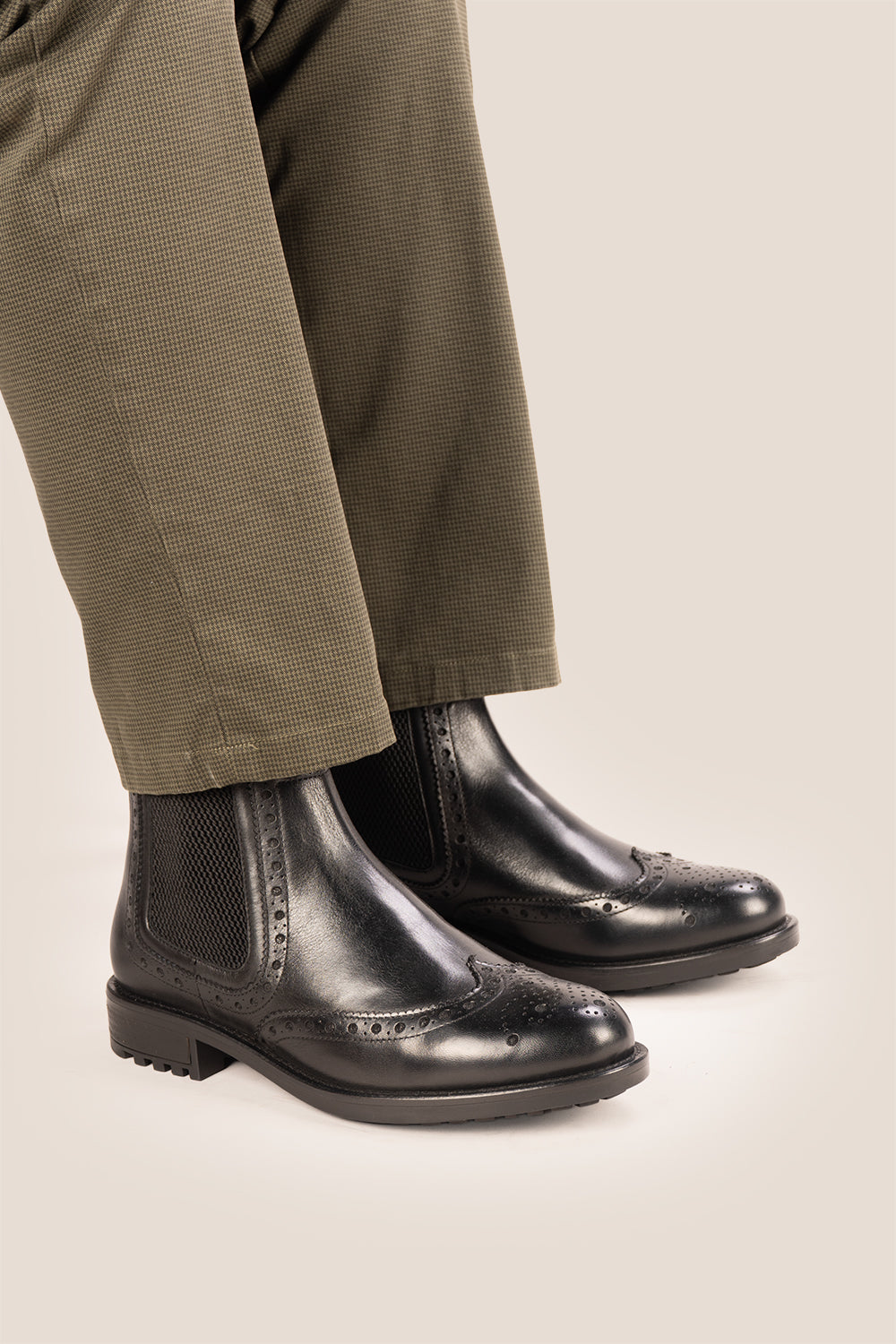 Gavin black leather Chelsea boots for men with intricate brogue detailing, showcasing timeless elegance and refined craftsmanship