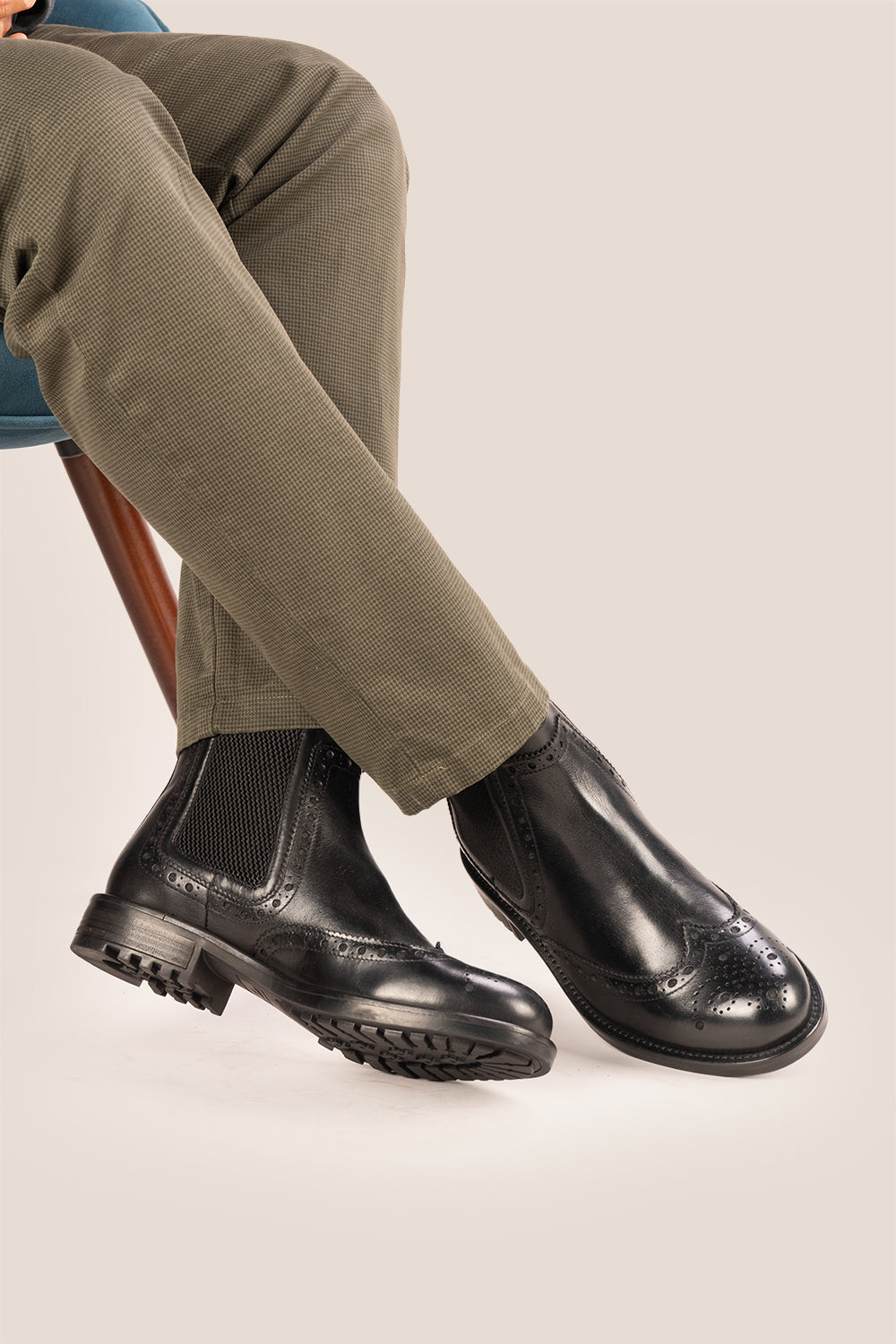 Gavin black leather Chelsea boots for men with intricate brogue detailing, showcasing timeless elegance and refined craftsmanship