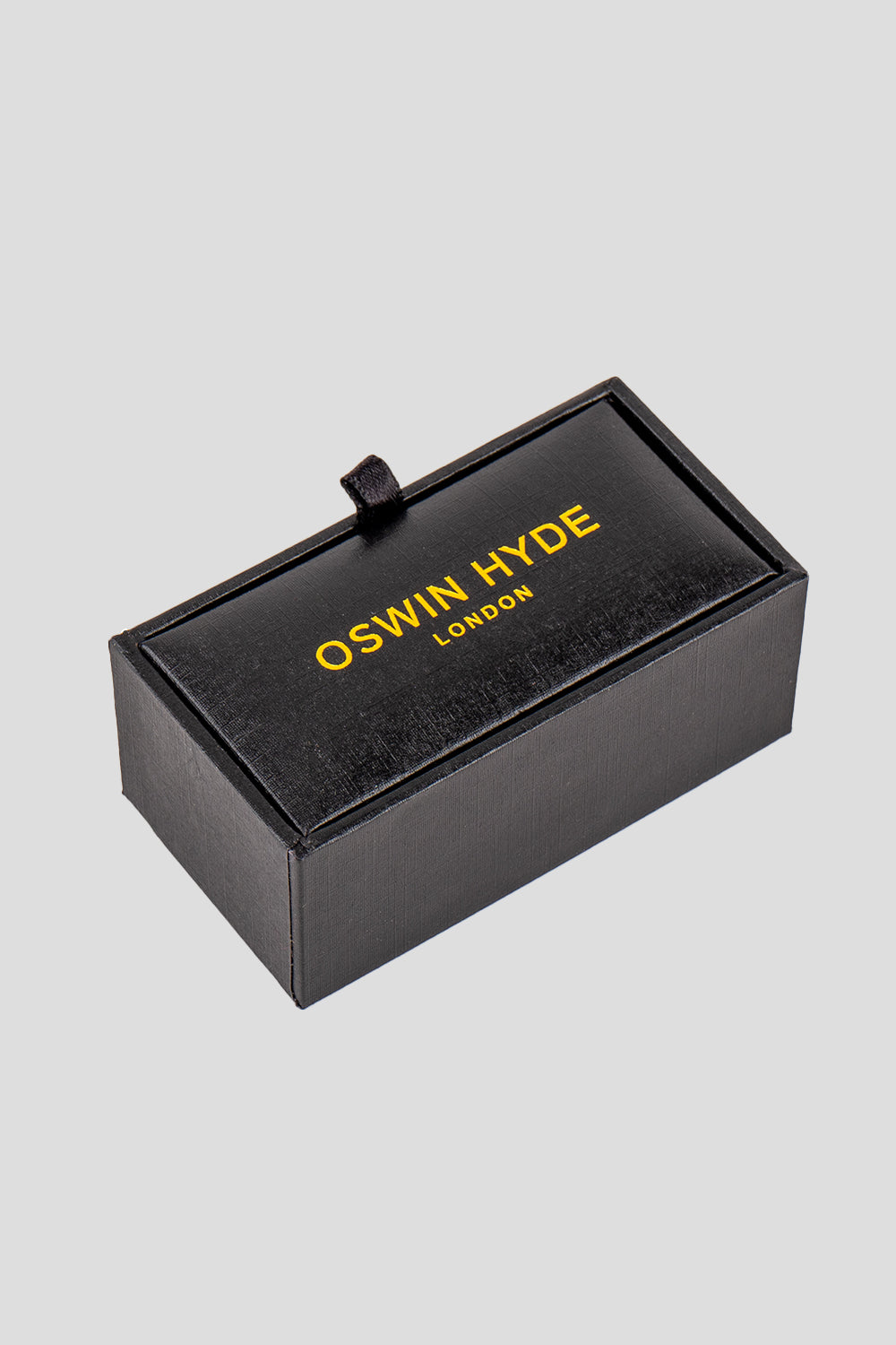 Square black men’s cufflinks featuring deep black enamel set in polished metal with intricate detailing for precise, formal elegance.