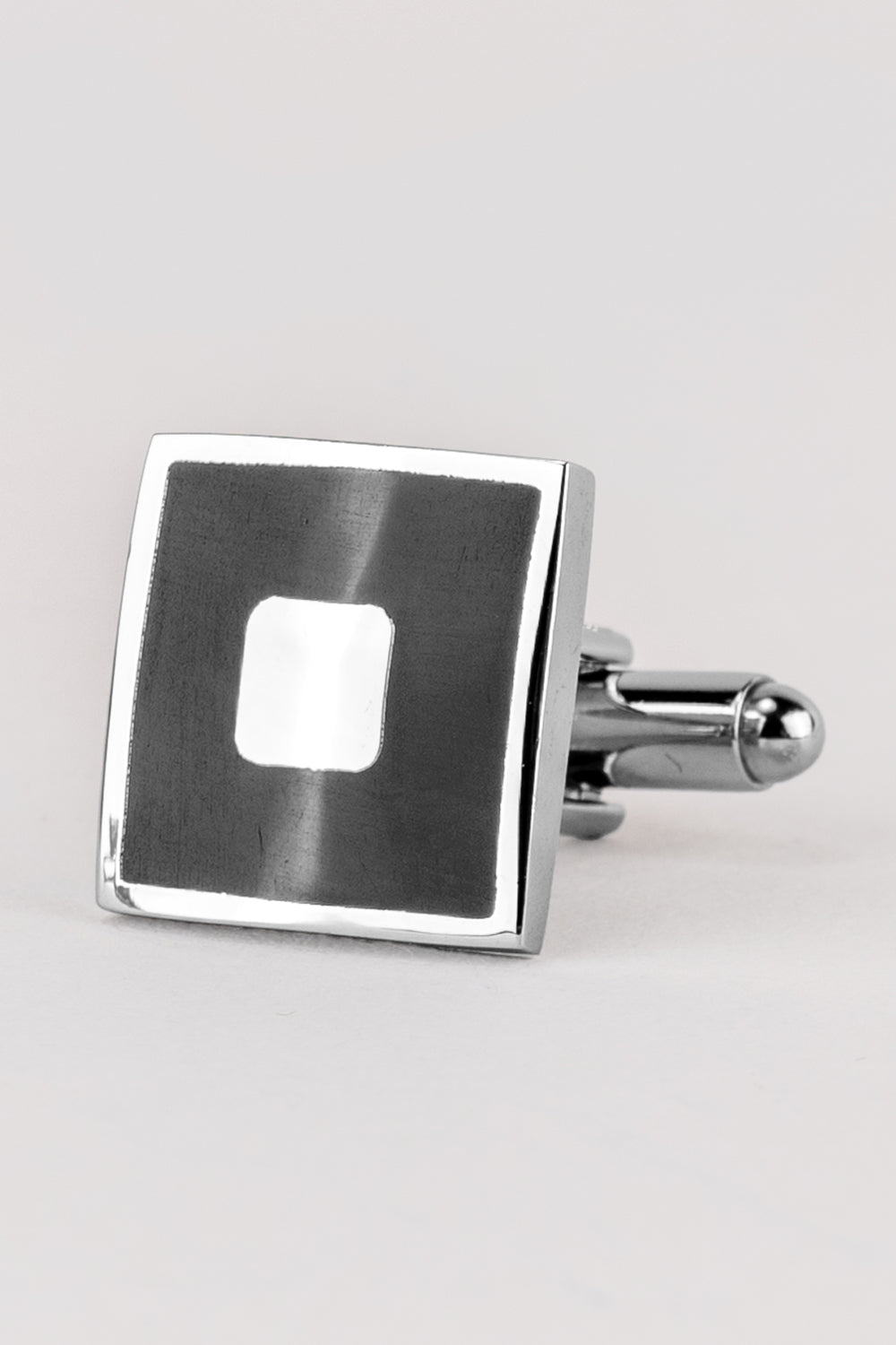 Square black men’s cufflinks featuring deep black enamel set in polished metal with intricate detailing for precise, formal elegance.