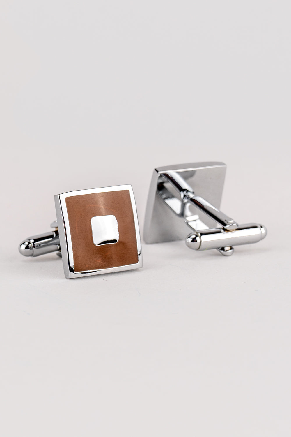 Square brown men’s cufflinks featuring rich enamel finish and intricate metal detailing, crafted for formal elegance and precision craftsmanship.